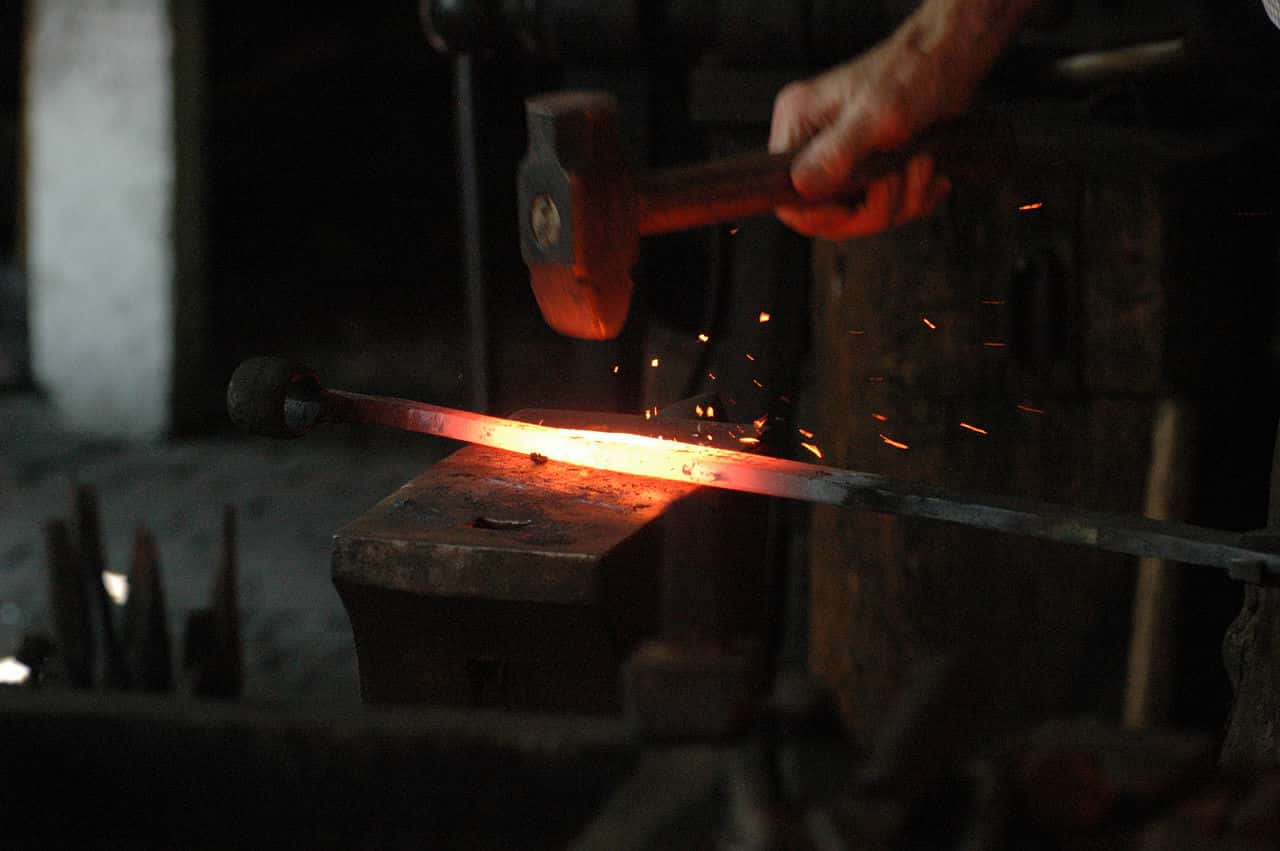1280px-Blacksmith_working