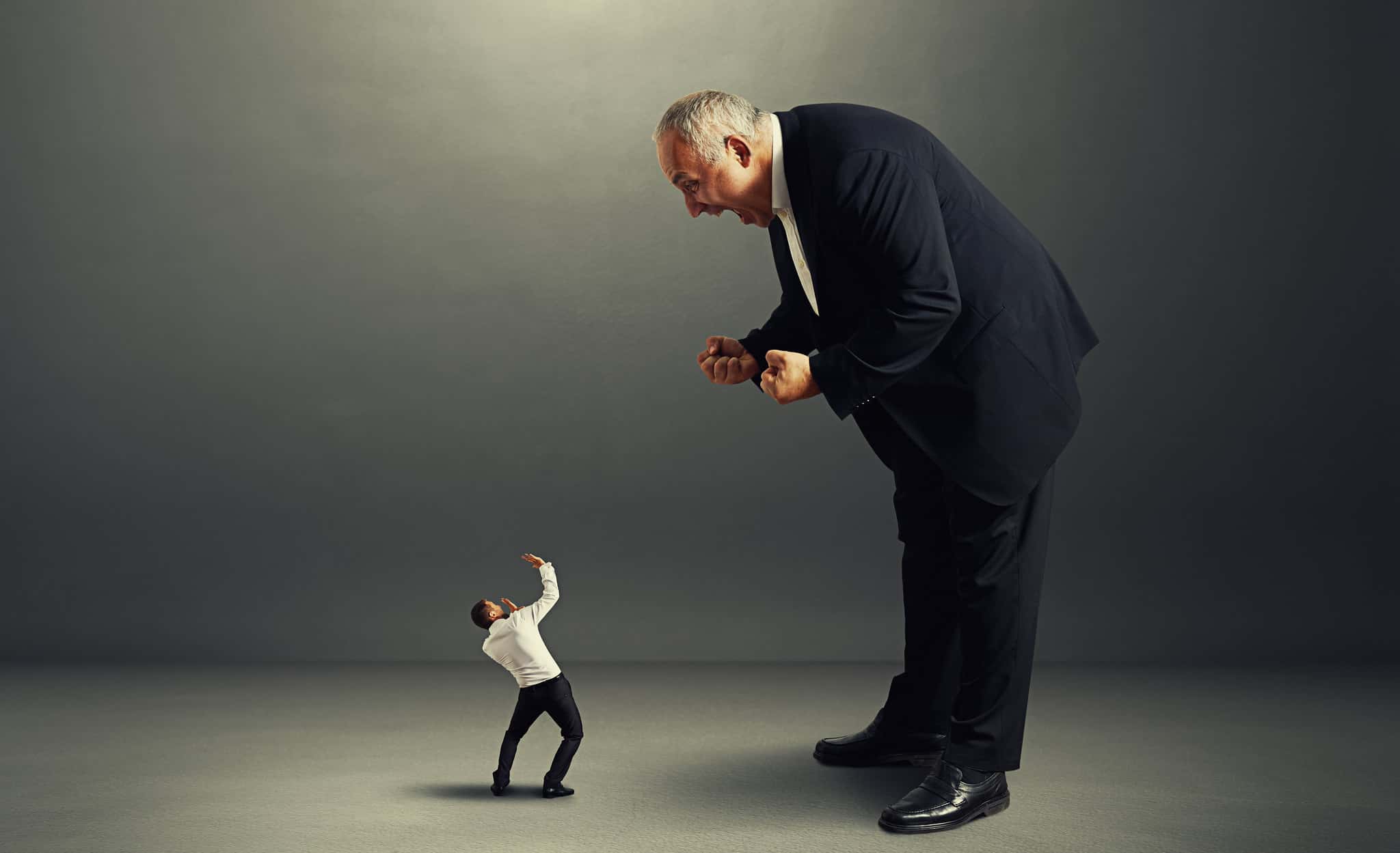 boss screaming at small startled worker