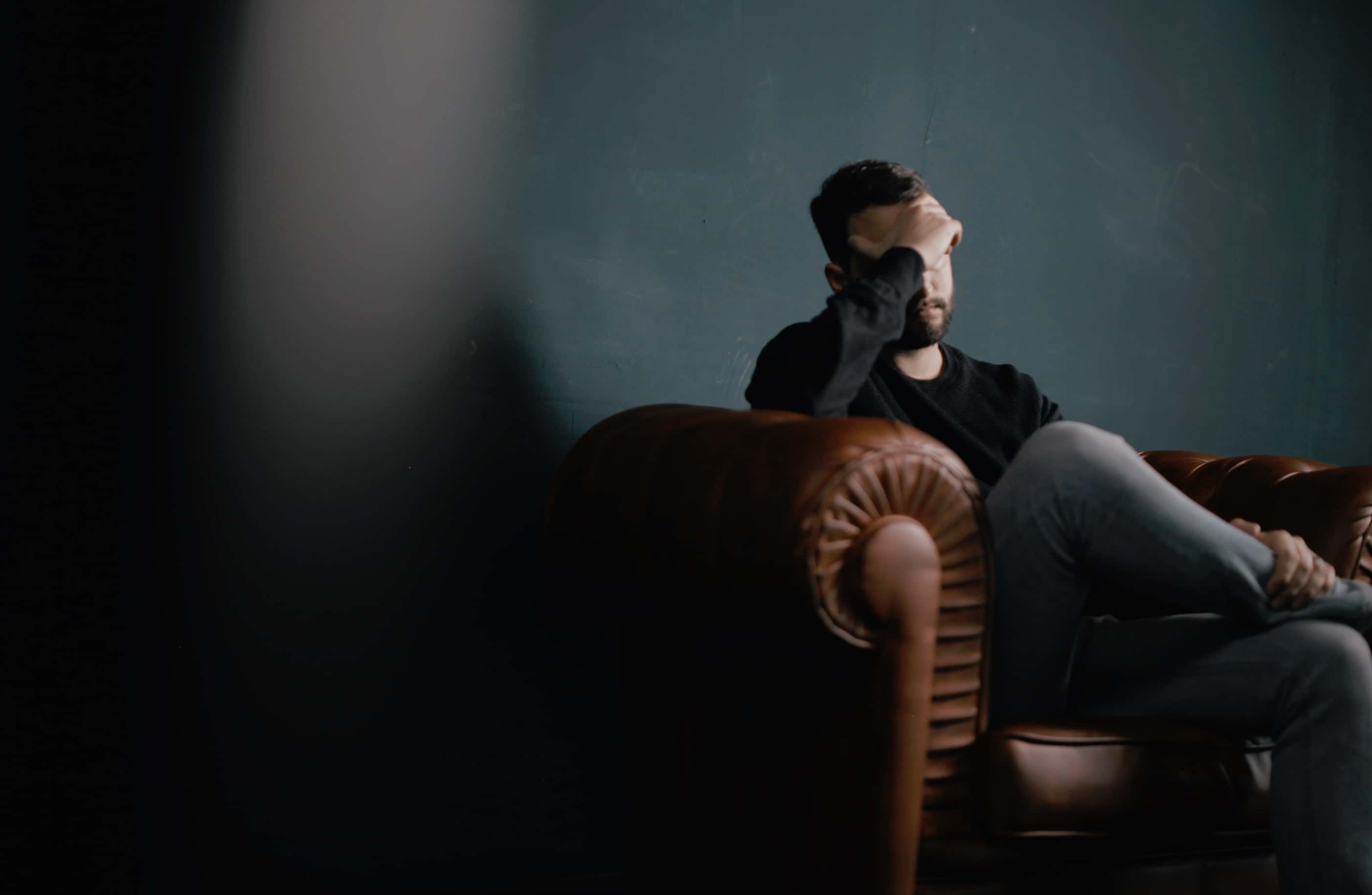 Canva - Frustrated Man Sitting on the Couch