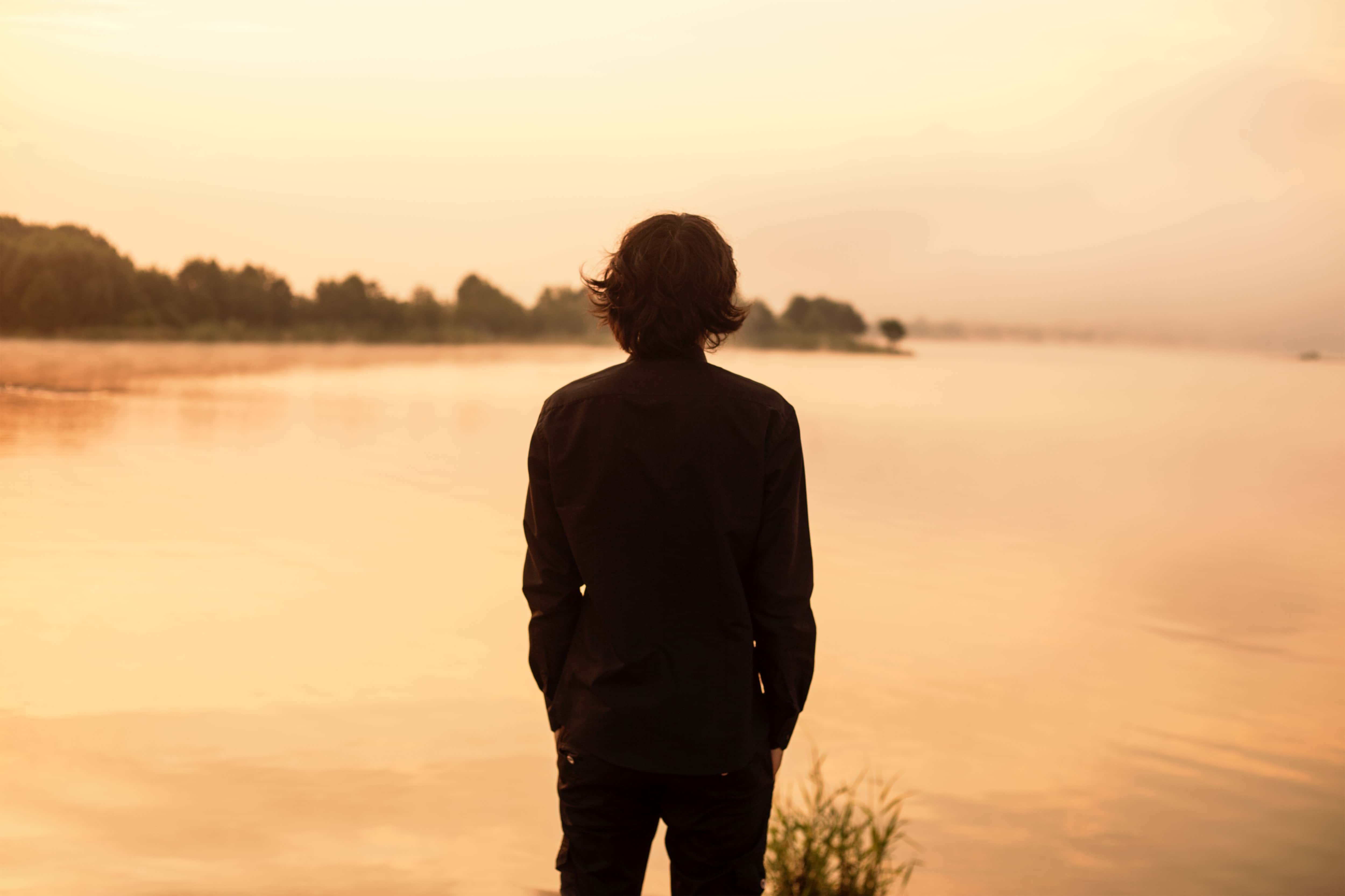 Canva - Man Looking at a Lake