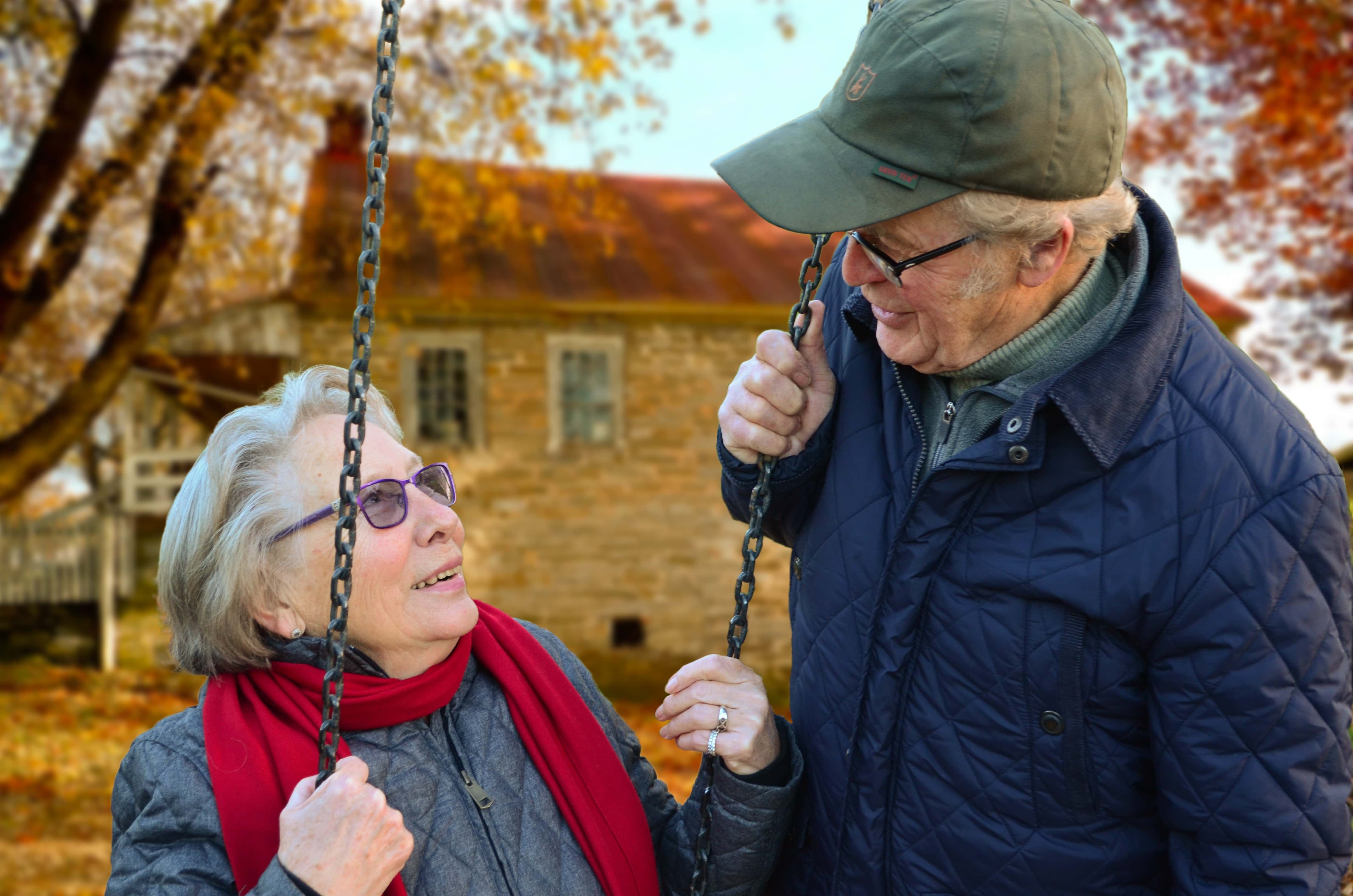 Canva - Man Standing Beside Woman on Swing