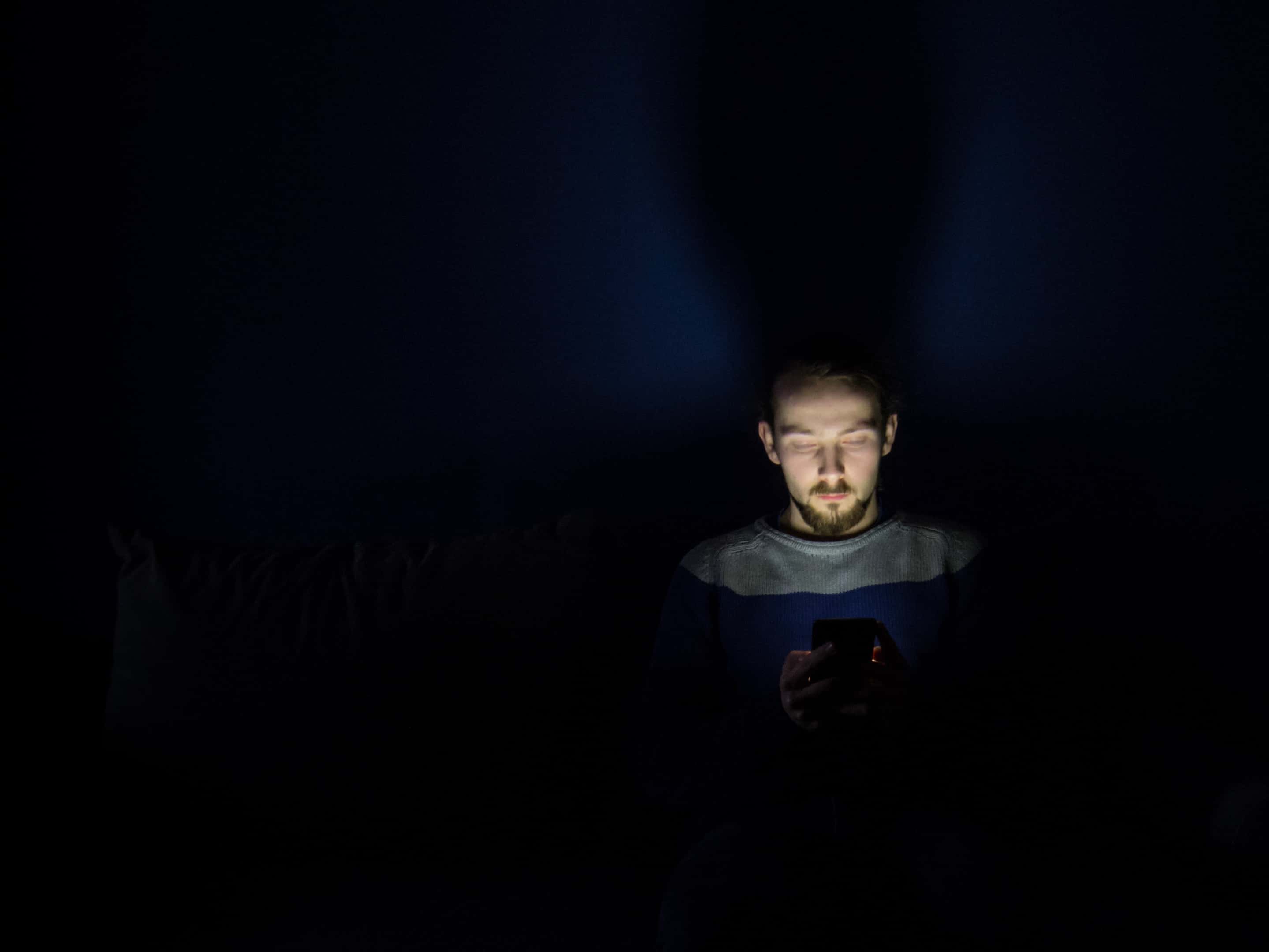 Canva - Man Using Smartphone at Night