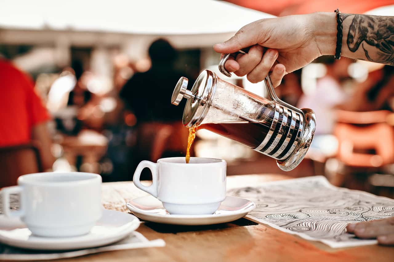 Canva - Person Pouring Coffee on White Ceramic Cup