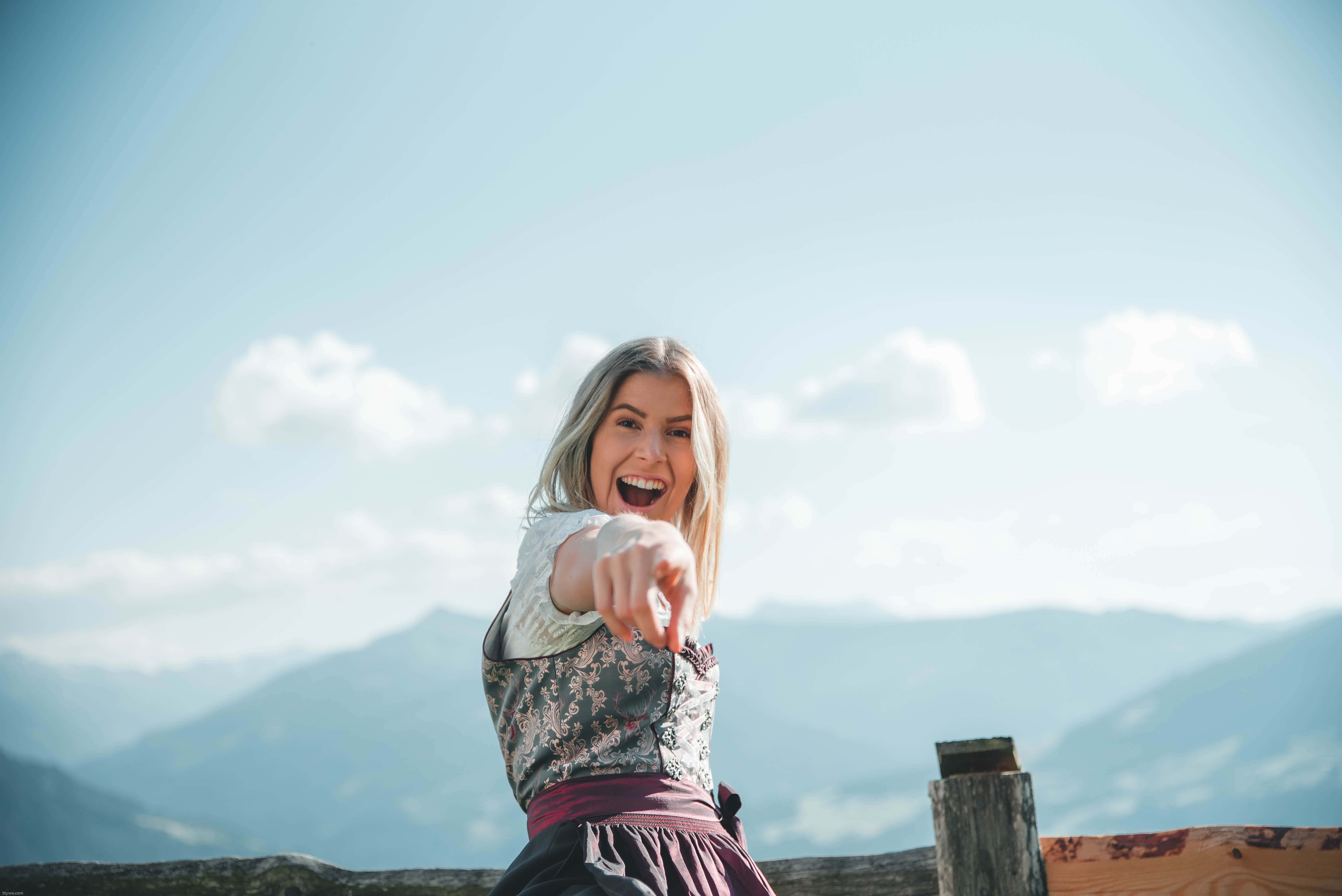 Canva - Smiling Woman Wearing Floral Dress Pointing With Right Hand