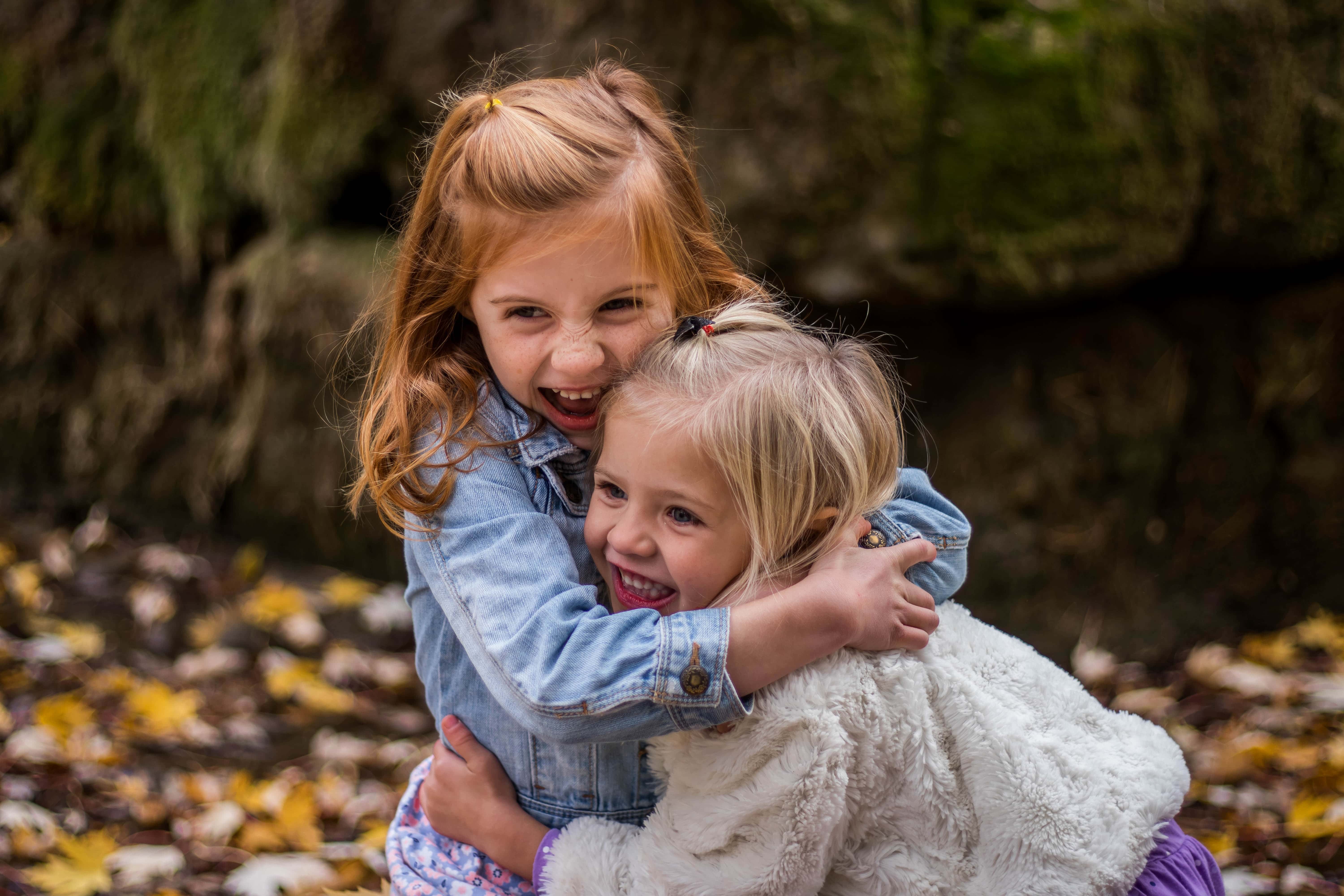 Canva - Two Cute Girls Hugging