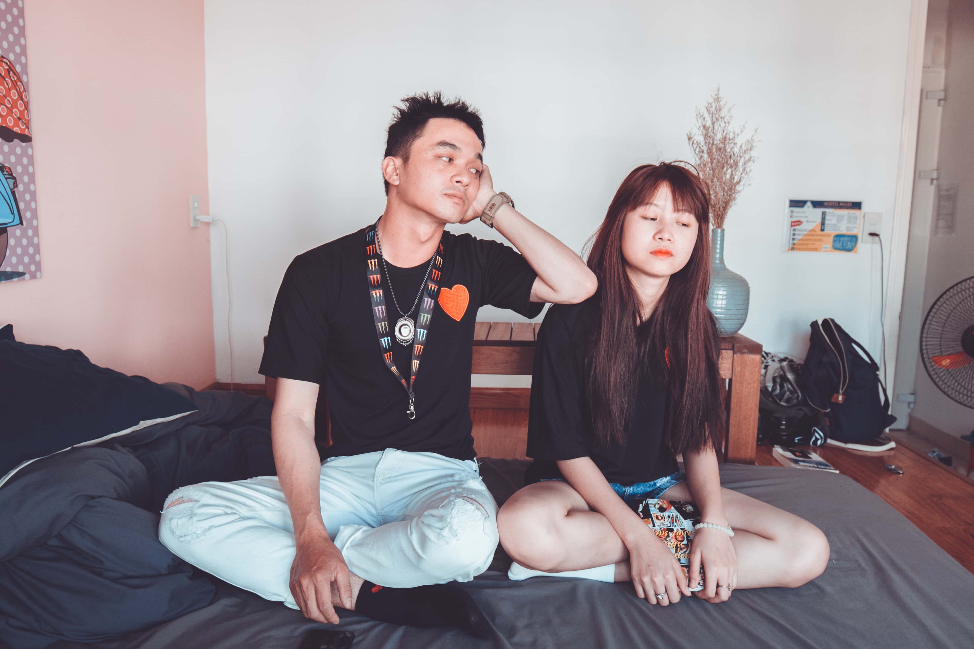 Canva - Two Man and Woman Sitting on Bed
