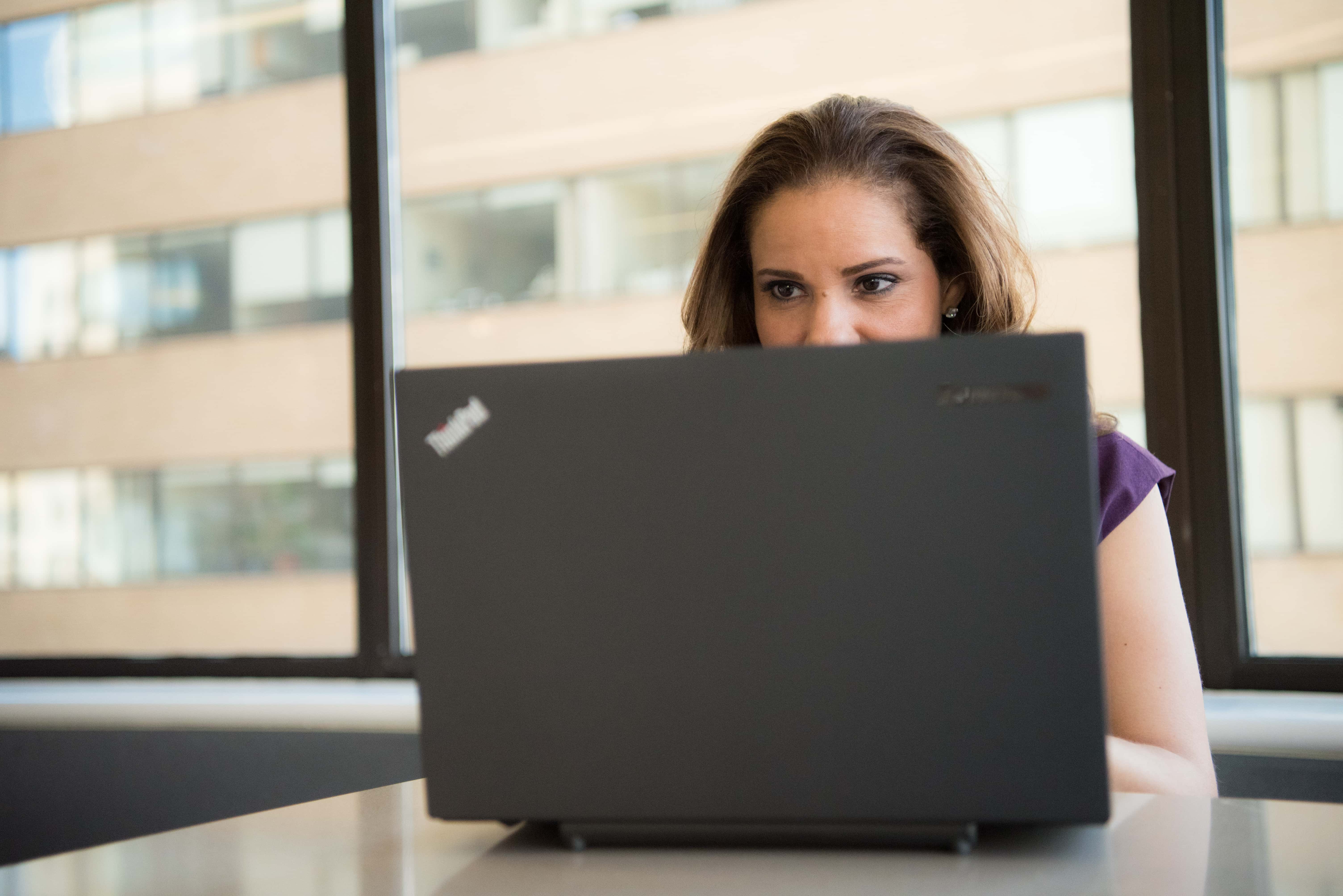 Canva - Woman Wearing Purple Top in Front of Lenovo Thinkpad