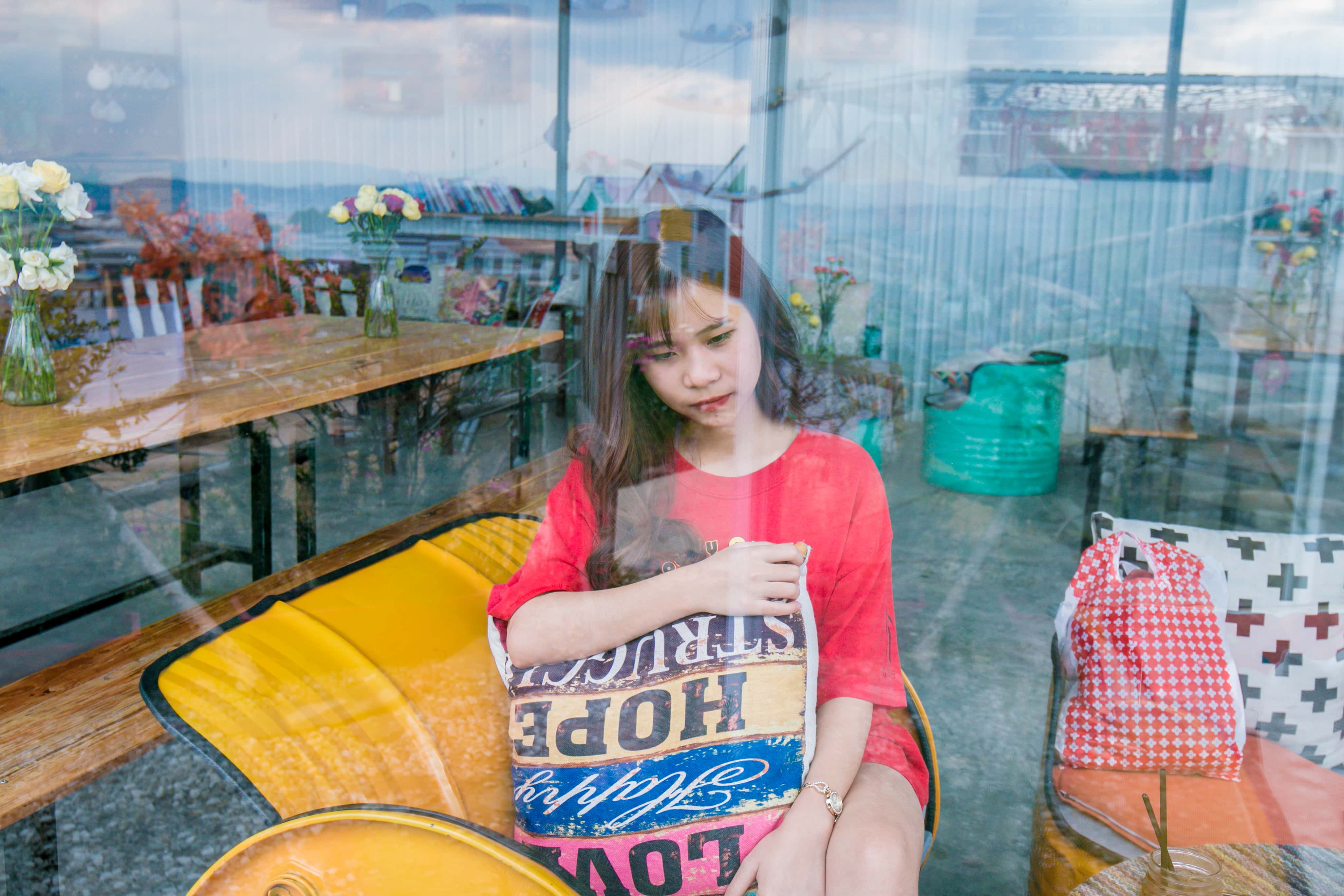 Canva - Woman Wearing Red Crew-neck T-shirt Sitting on Yellow Sofa Chair