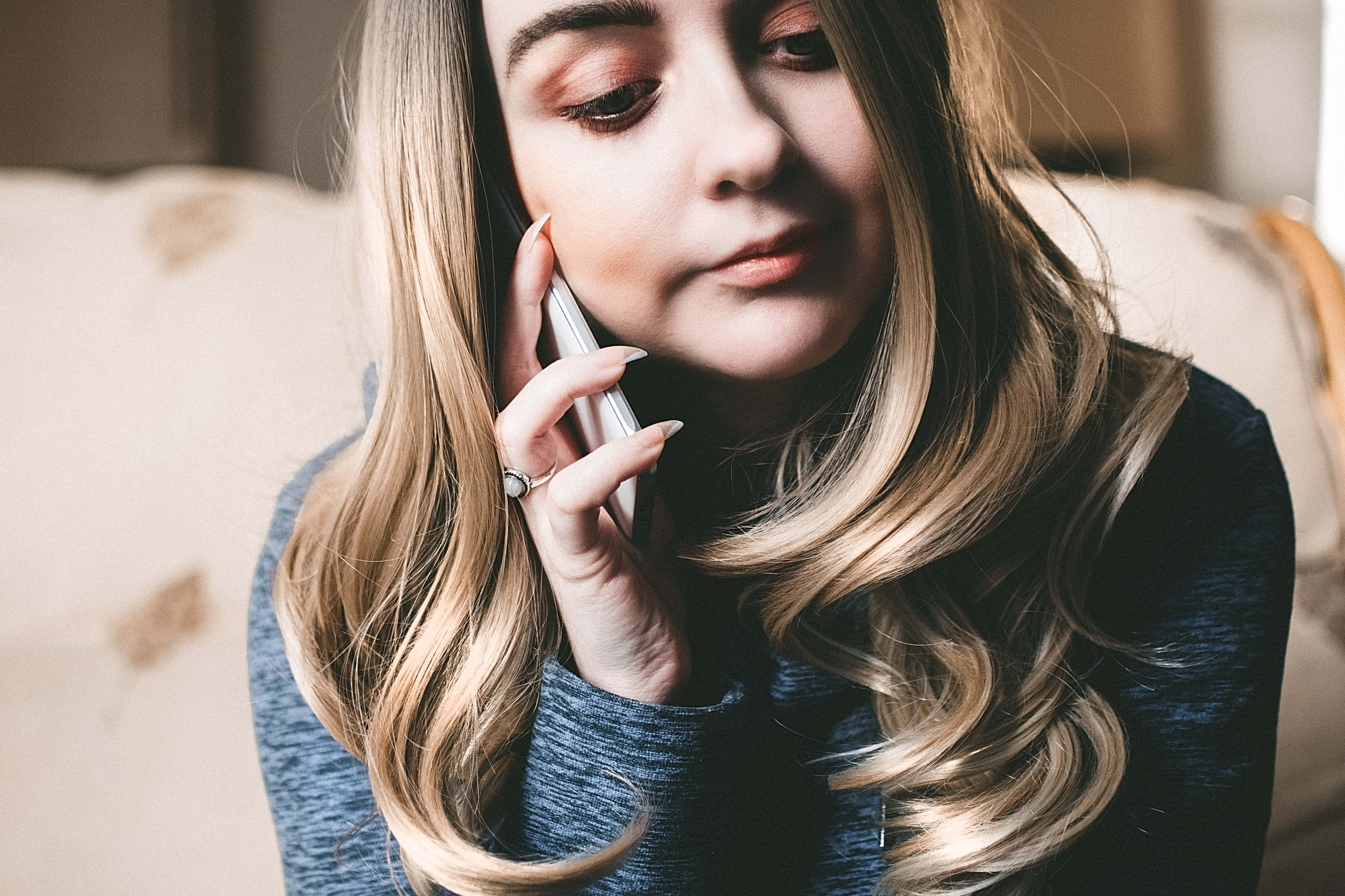 Canva - Woman in Gray Top Using Her Mobile Phone