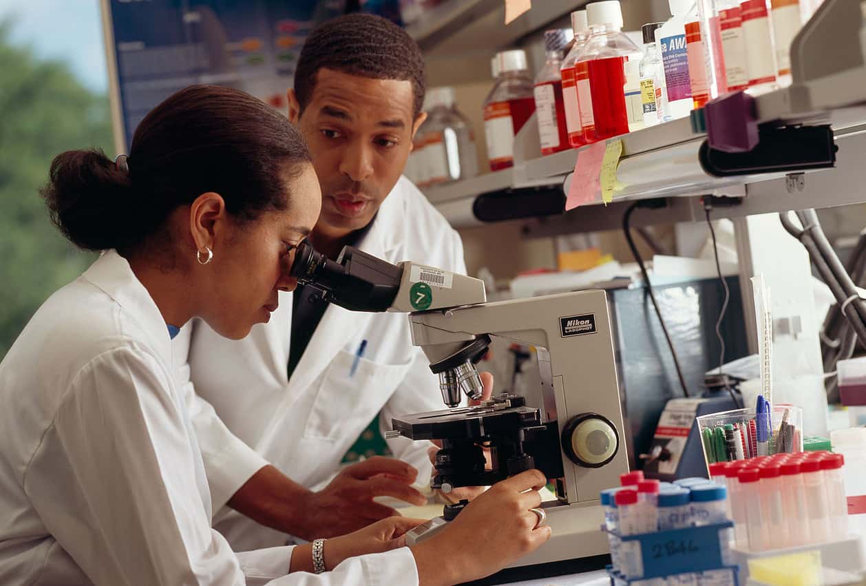 1258px-Researcher_looks_through_microscope(1)