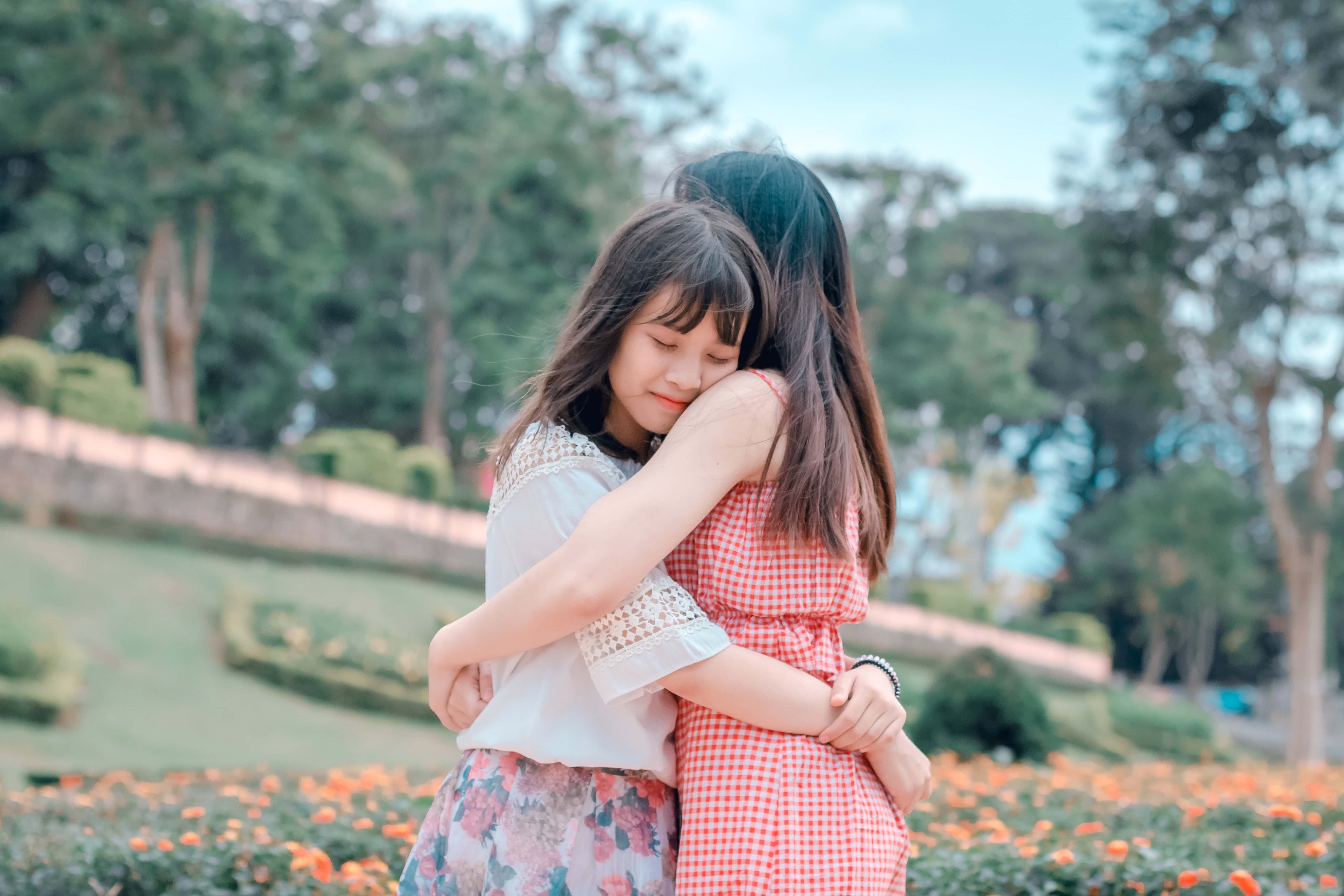 Canva - Candid Photography of Two Female Hugging