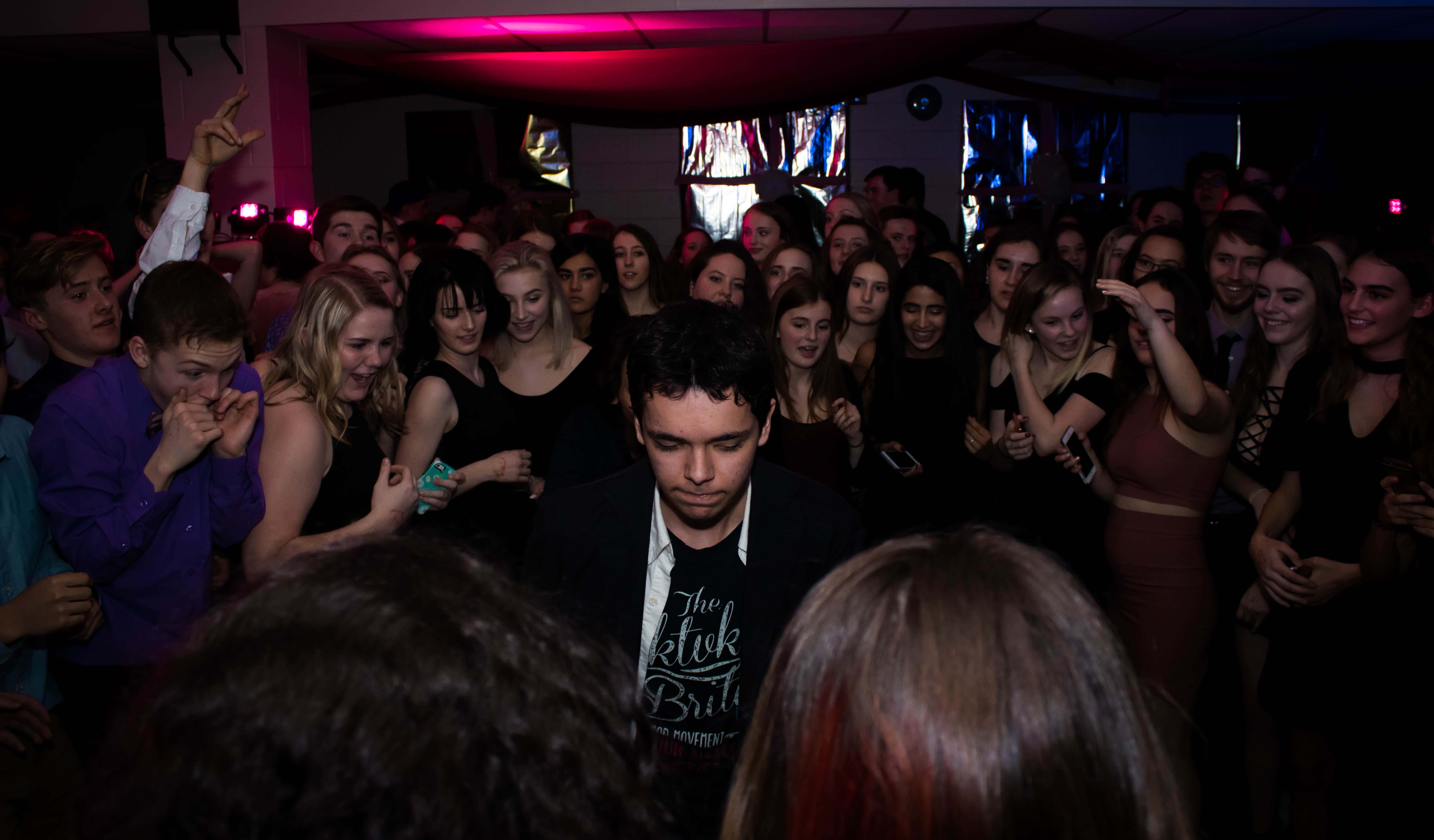 Canva - Man Standing in the Center of Crowd