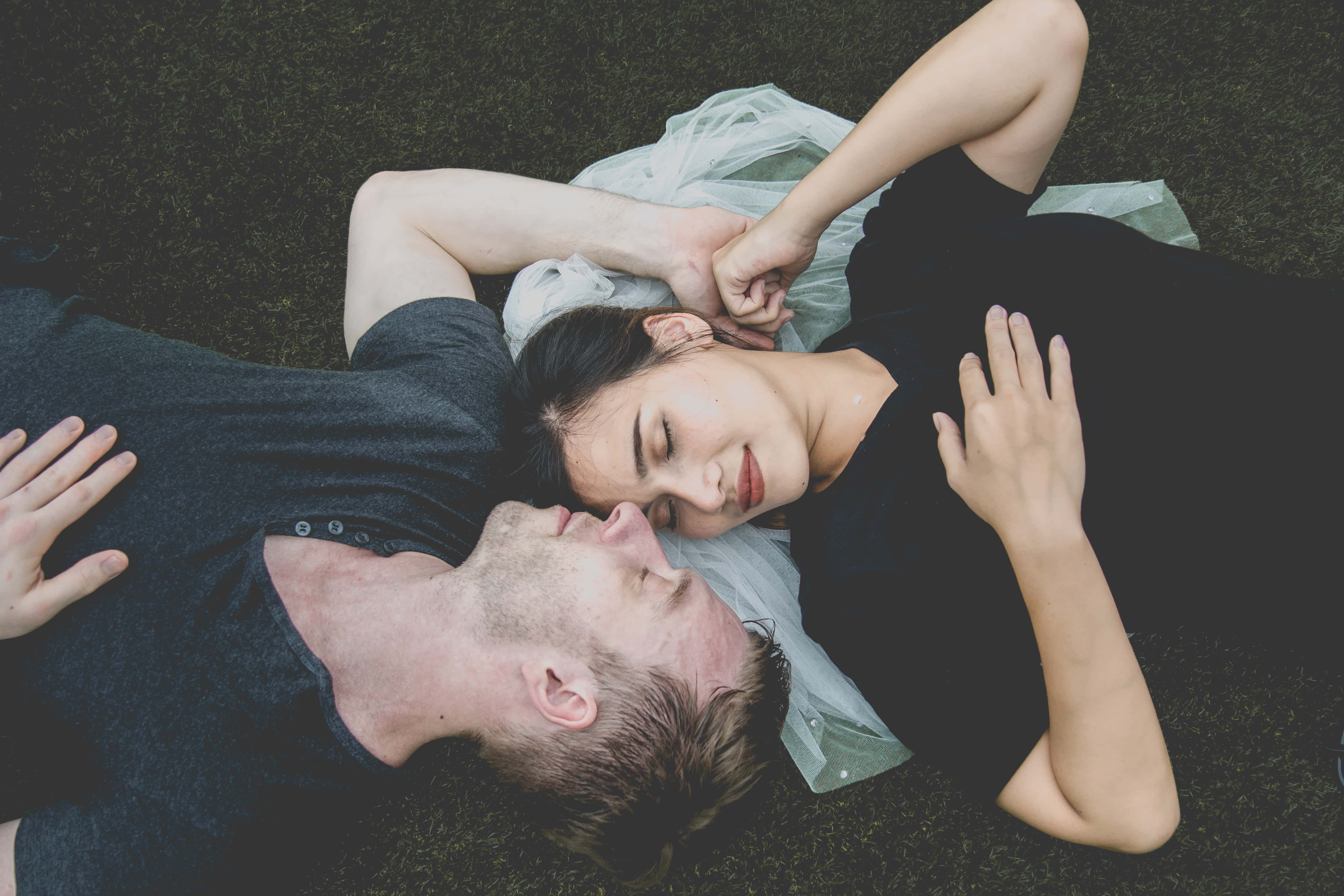 Canva - Man and Woman Lying on Ground Posing for Photo