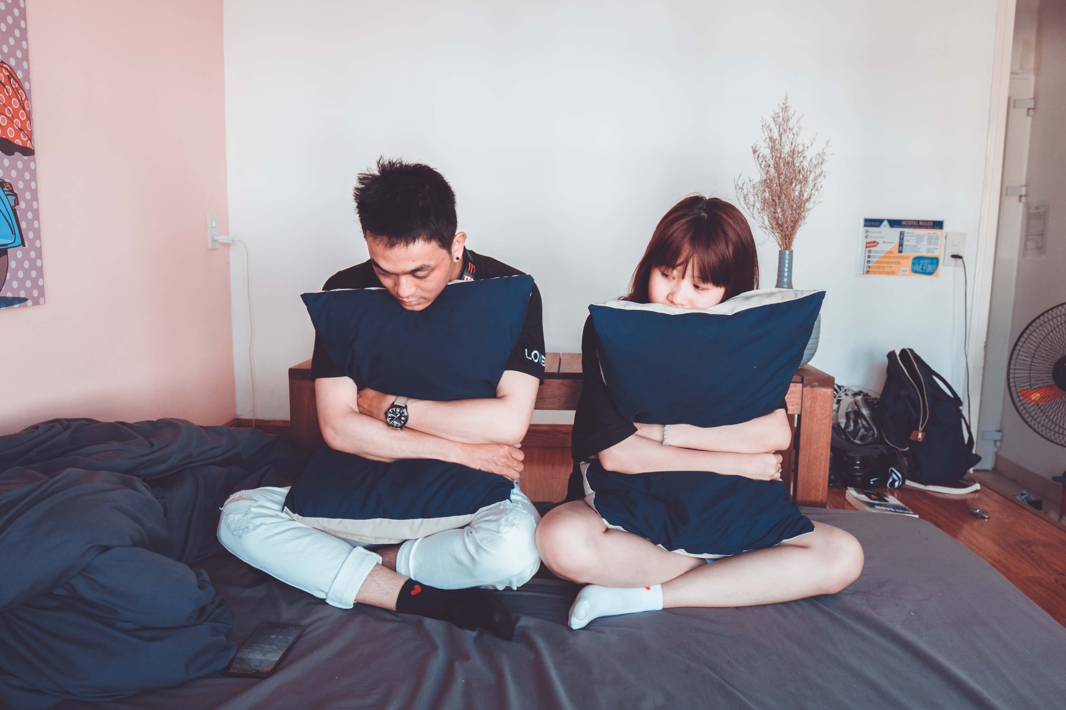 Canva - Man and Woman Sitting on Bed