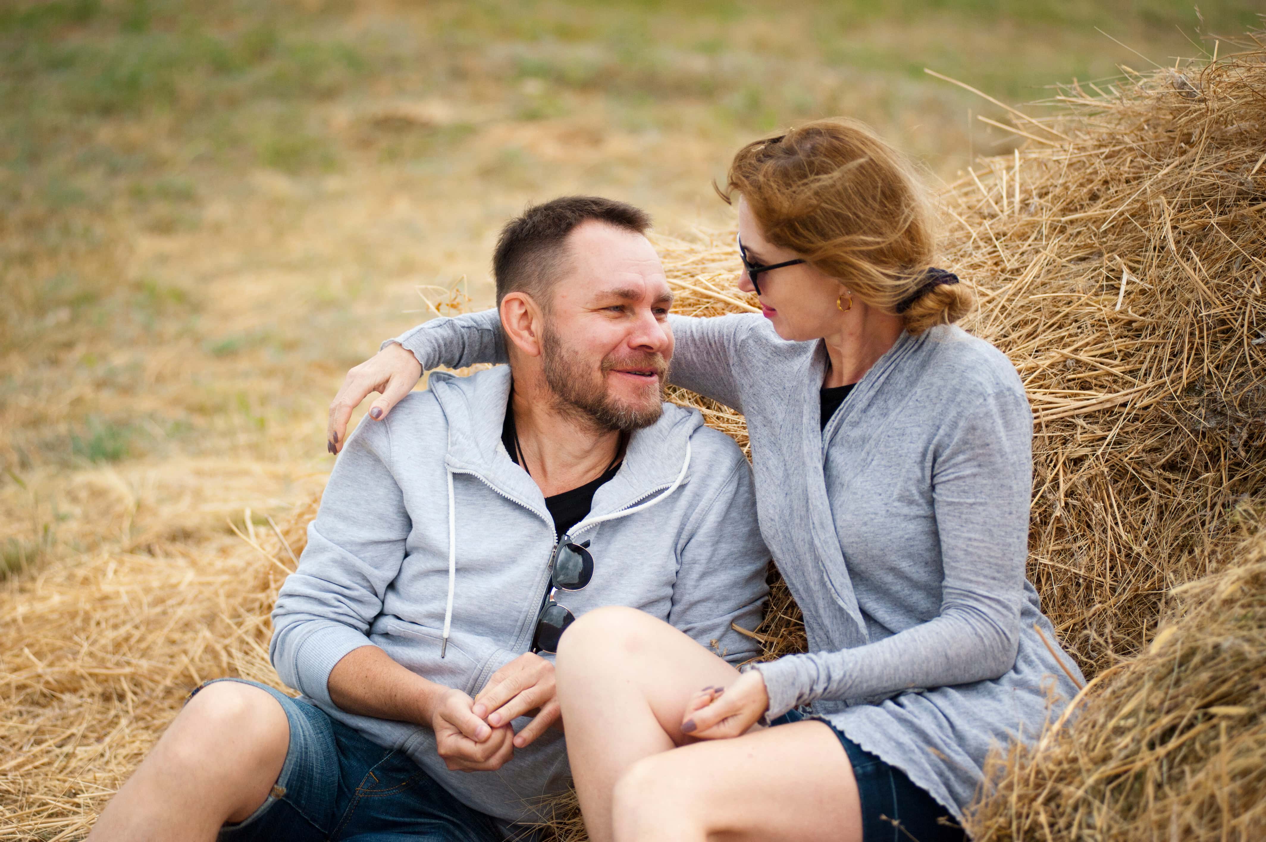 Canva - Man and Woman Sitting on Hay