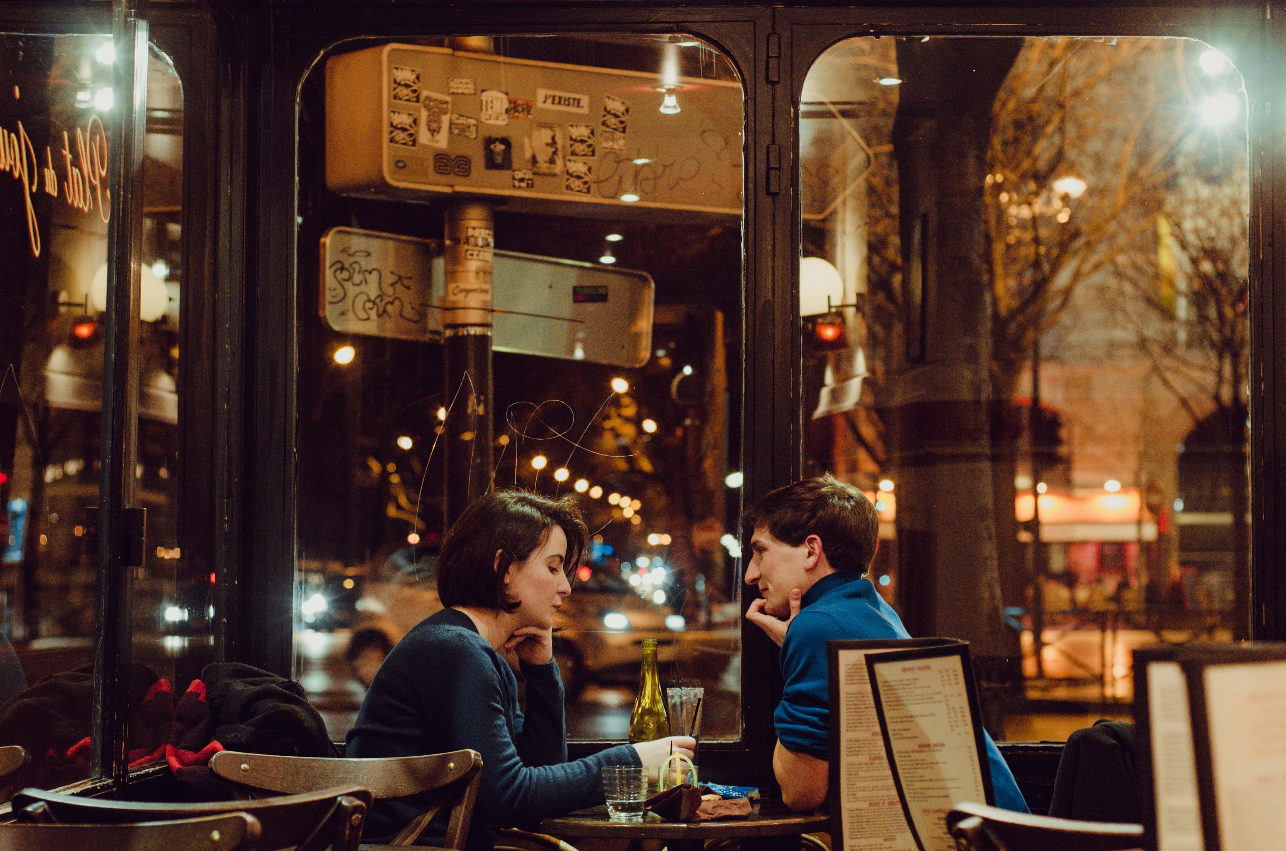 Canva - Selective Focus Photography of Man and Woman Sitting on Chair Inside Restaurant during Nighttime