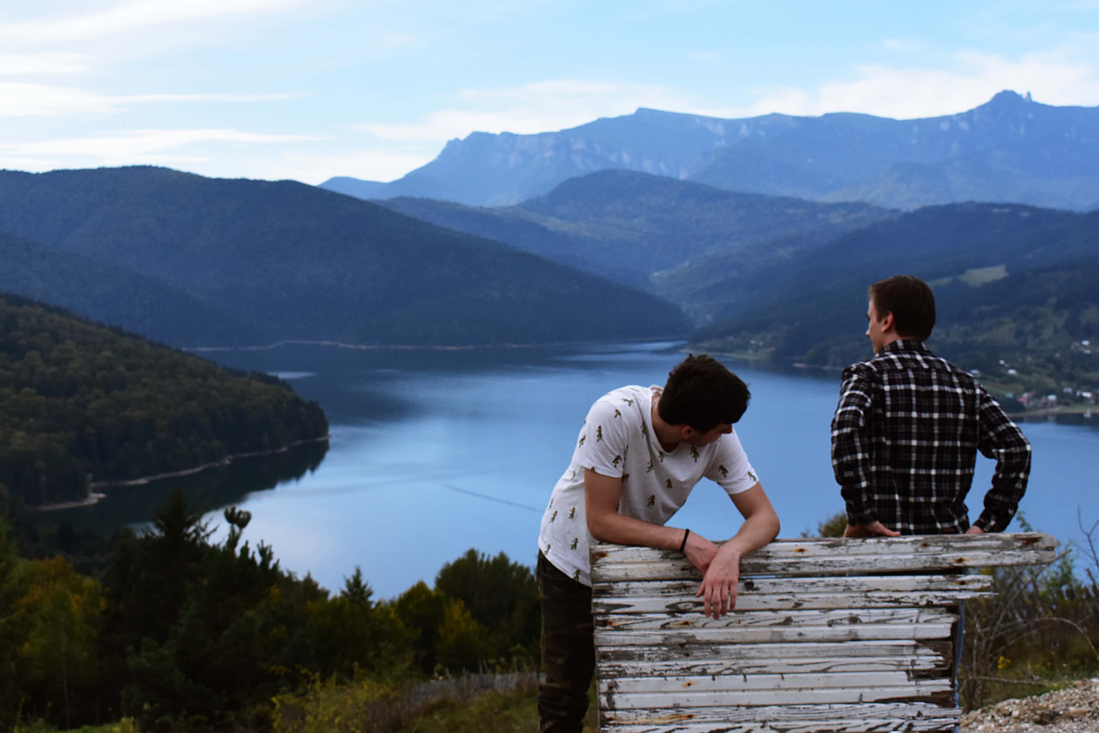 Canva - Two Man Near White Wooden Fence