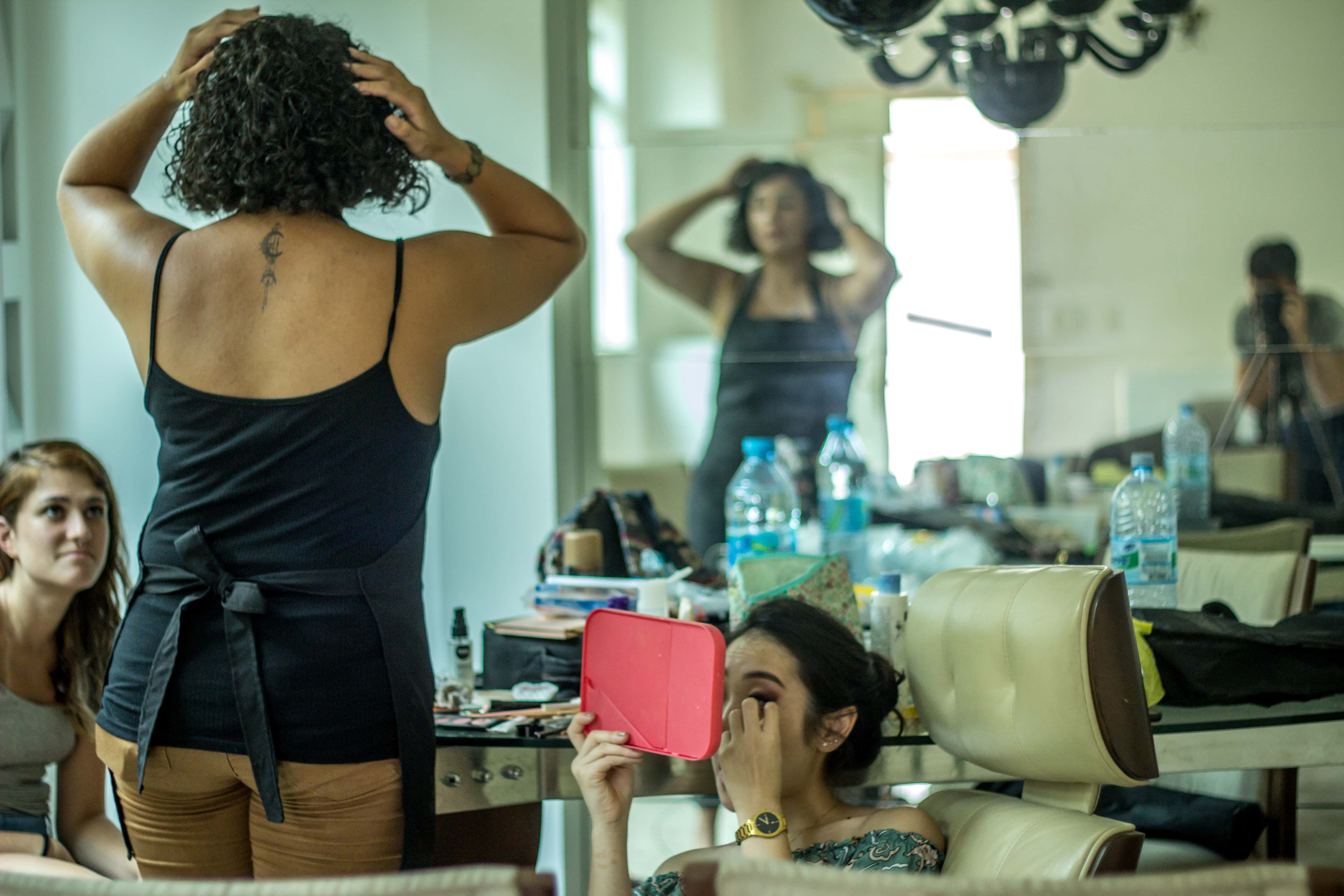 Canva - Woman In Black Spaghetti Strap Top Beside Woman Sitting Holding Pink Mirror