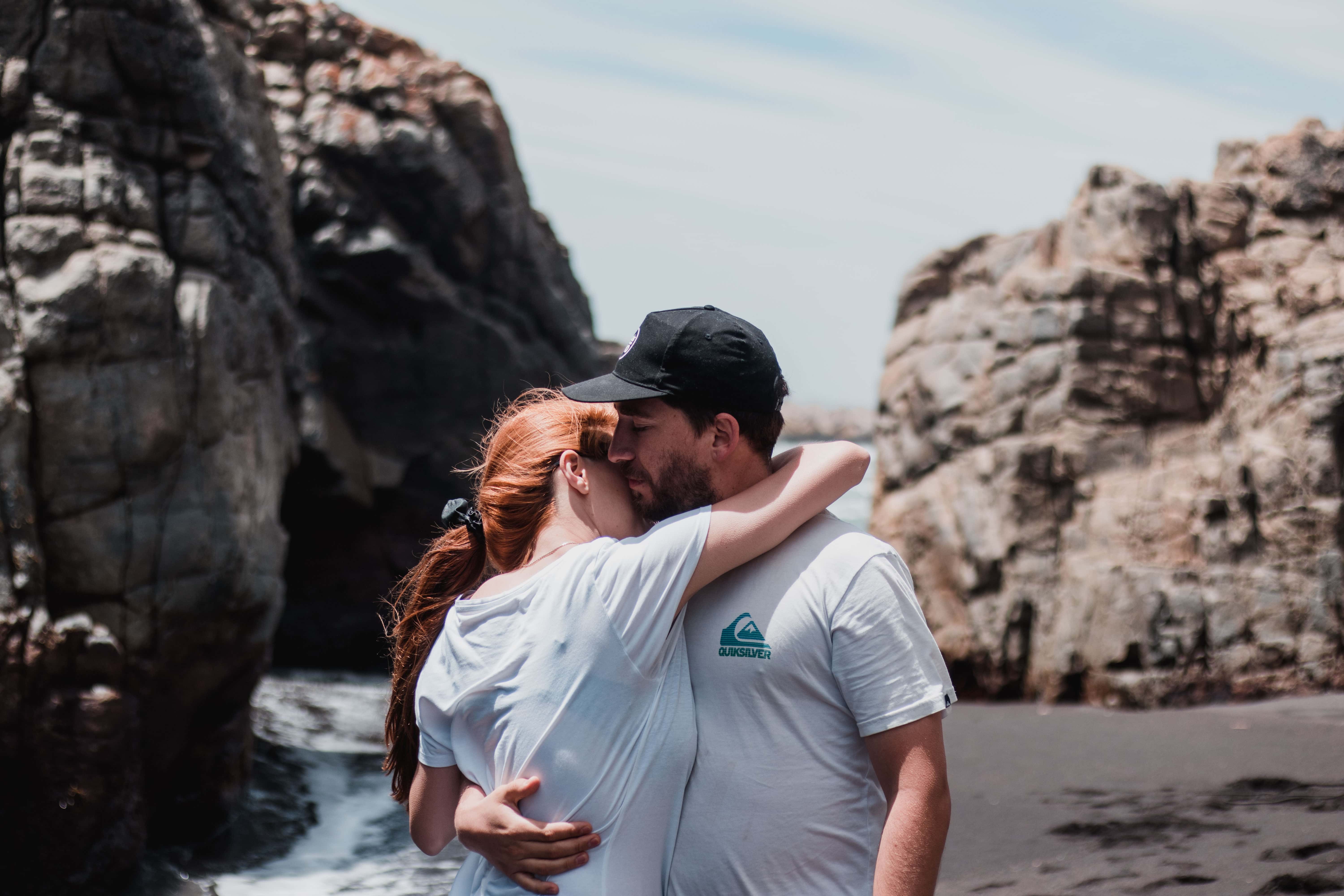 Canva - Woman and Man Hugging Each Other Under Cloudy Sky