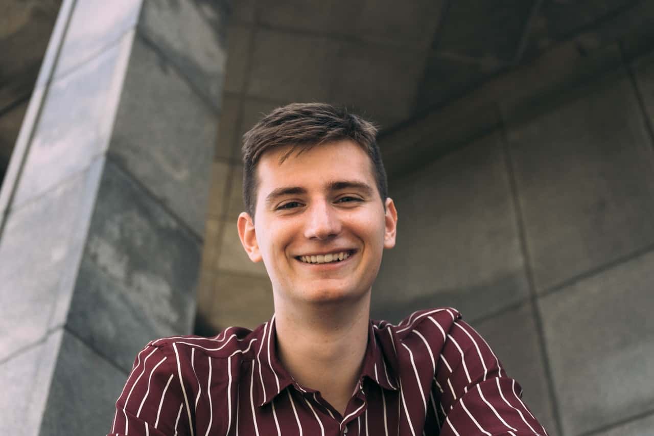 man-in-red-and-white-striped-collared-shirt-smiling-1109637