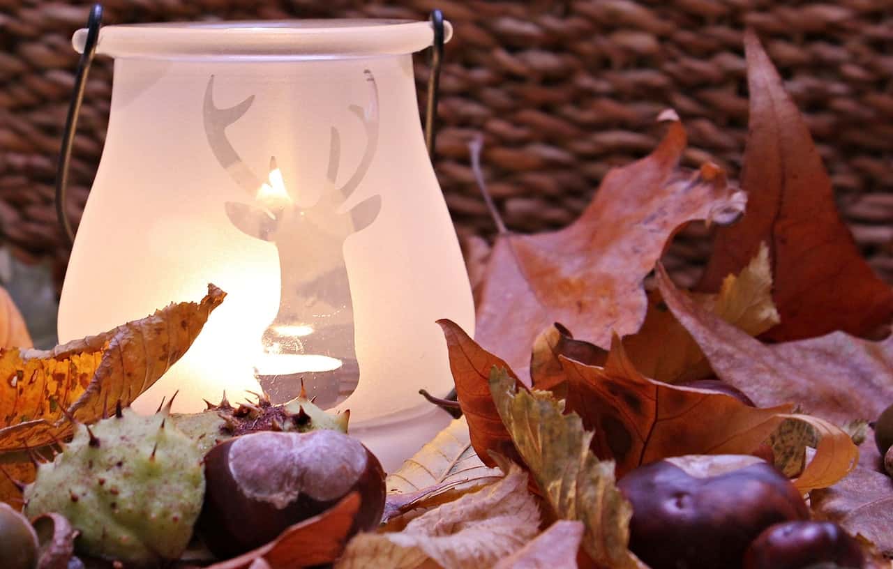 white-ceramic-lamp-with-deer-cutout-near-leaves-207102