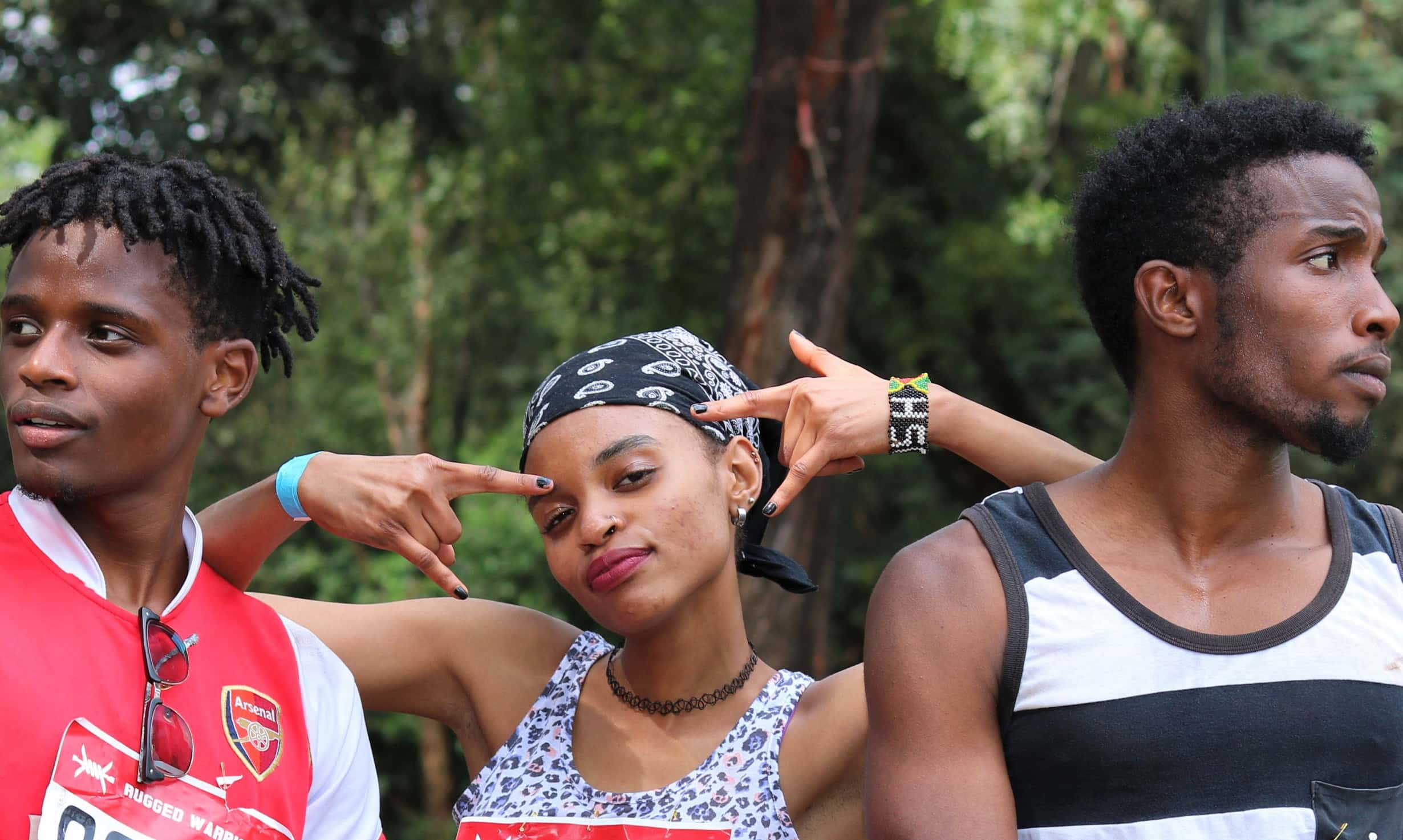 woman-standing-between-two-men-standing-on-green-grass-near-1365450(1)