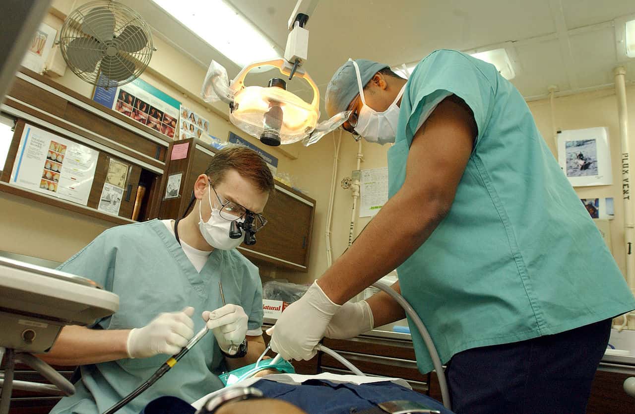 1280px-US_Navy_030124-N-1328C-510_Navy_dentist_treats_patients_aboard_ship