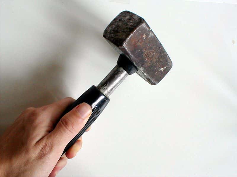 1762-hand-holding-a-worn-mallet-pv