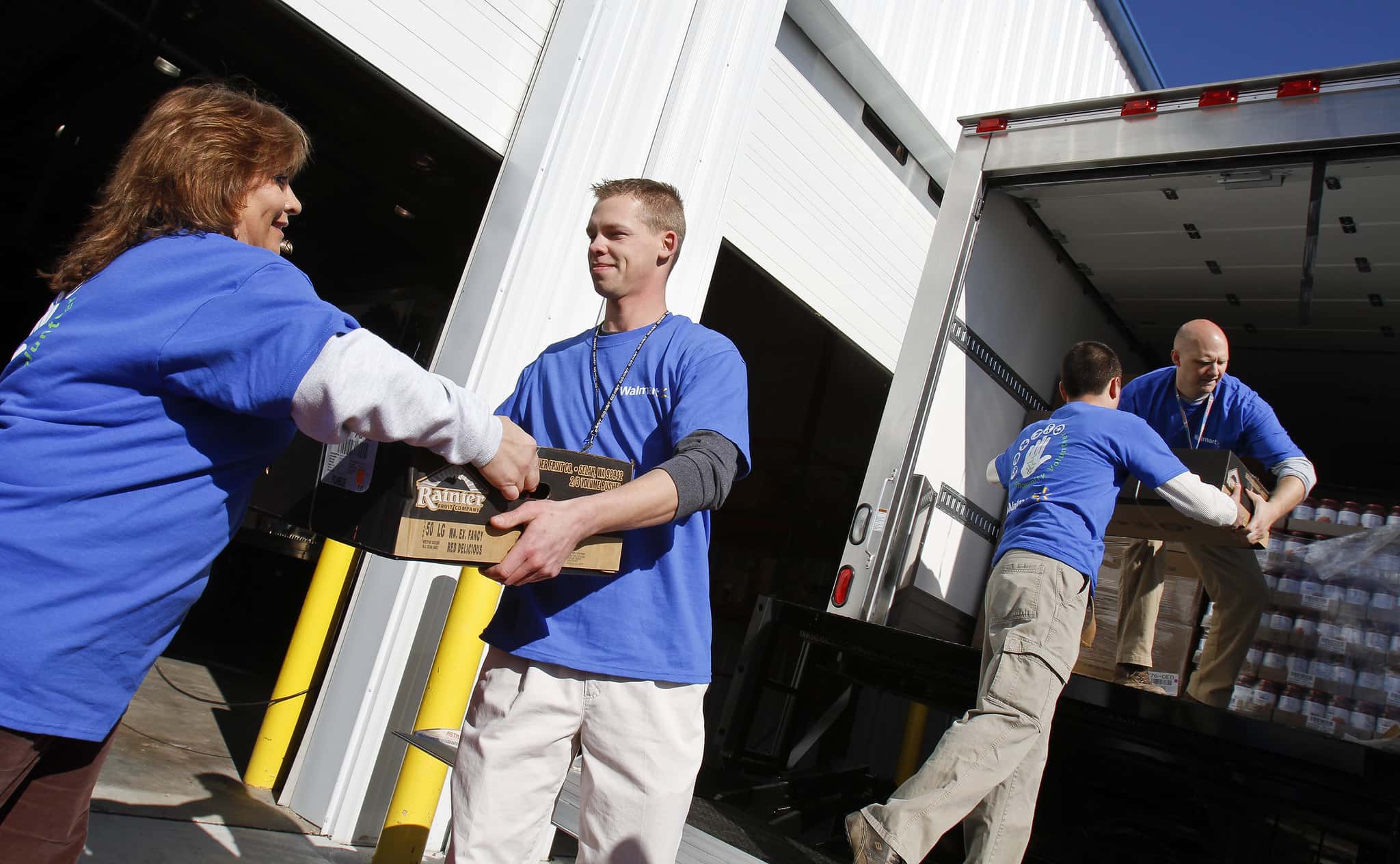 Patti Pflueger, left, Michael Taylor, Daniel Hosterman and Michael Egan load up