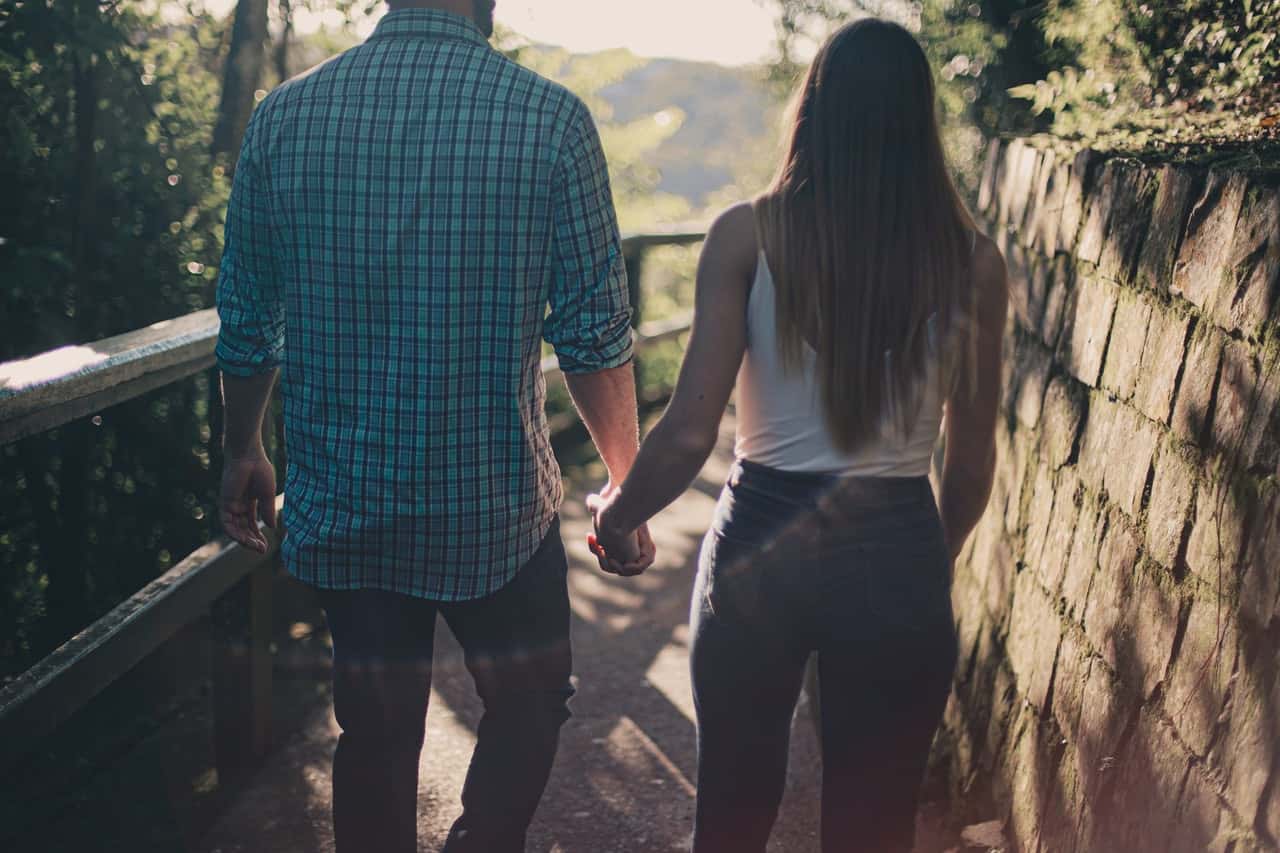 back-view-photo-of-couple-holding-hands-while-walking-along-2379010