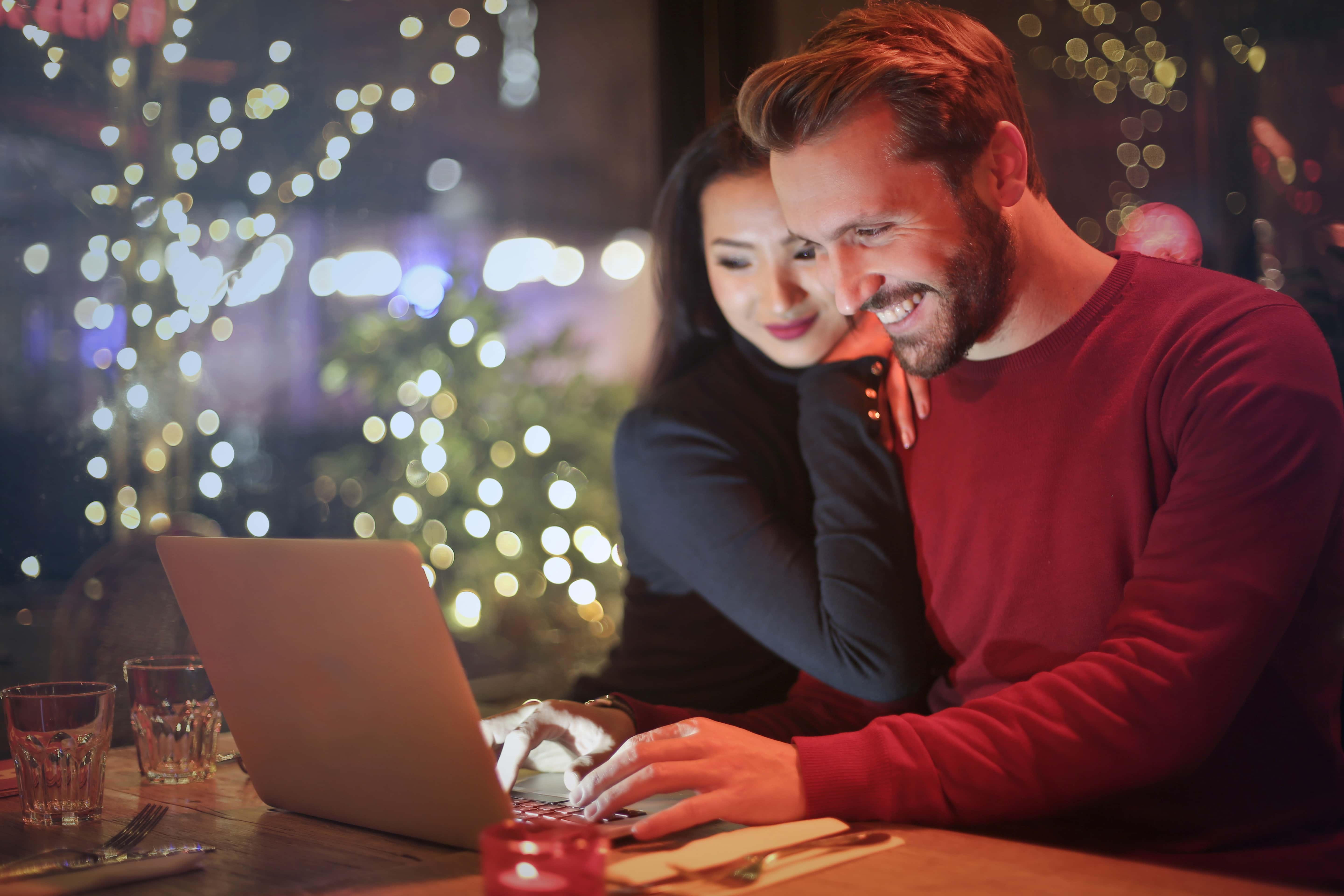 cute-couple-working-on-a-laptop