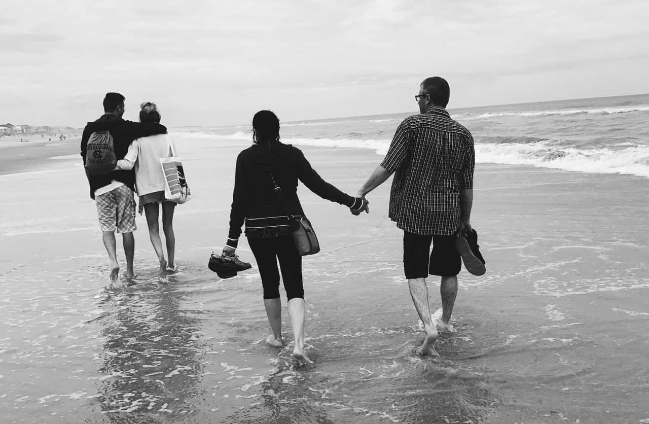 gray-scale-of-two-couples-on-the-beach-952067