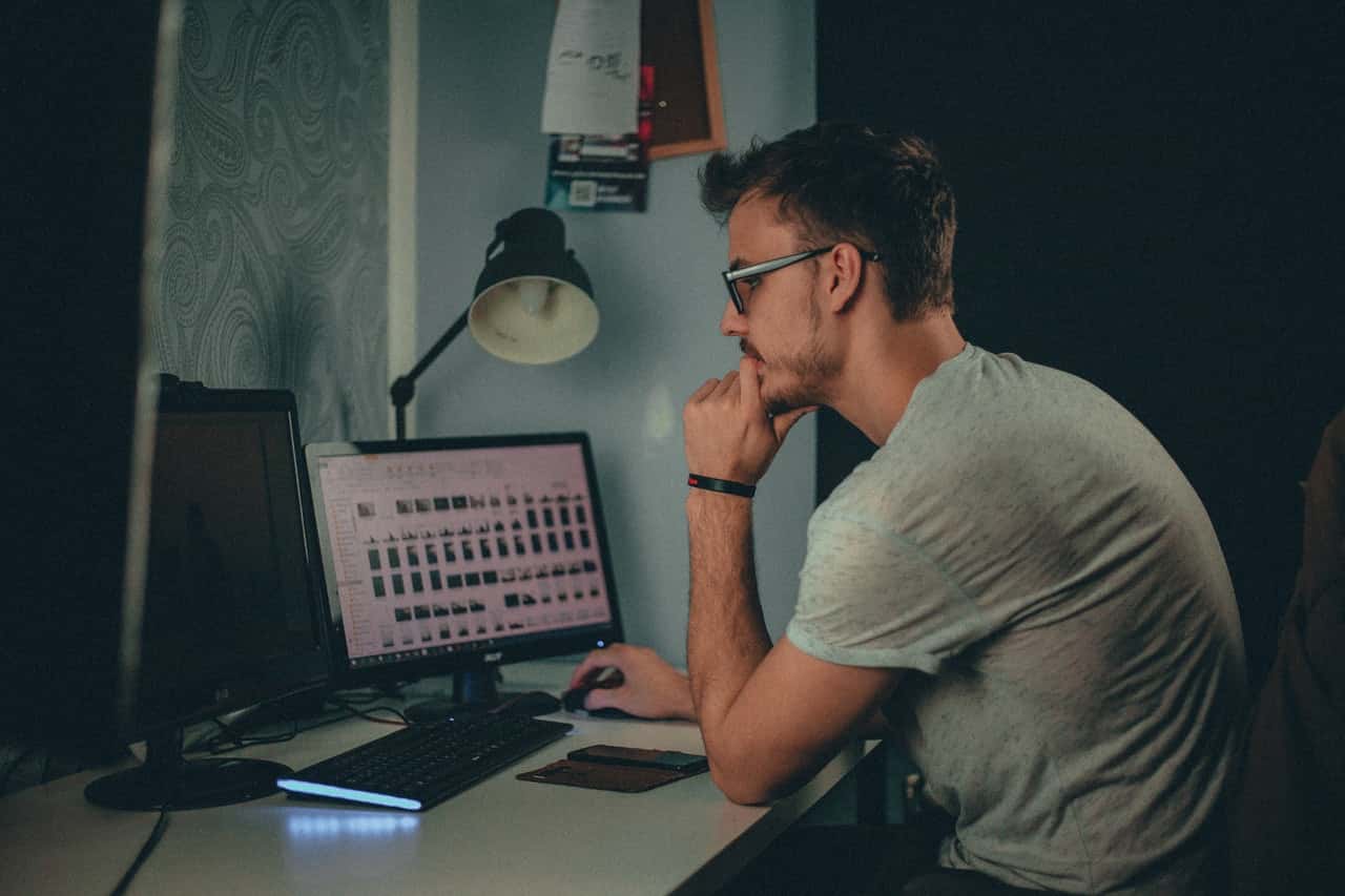 man-using-computer-sitting-on-chair-1981443