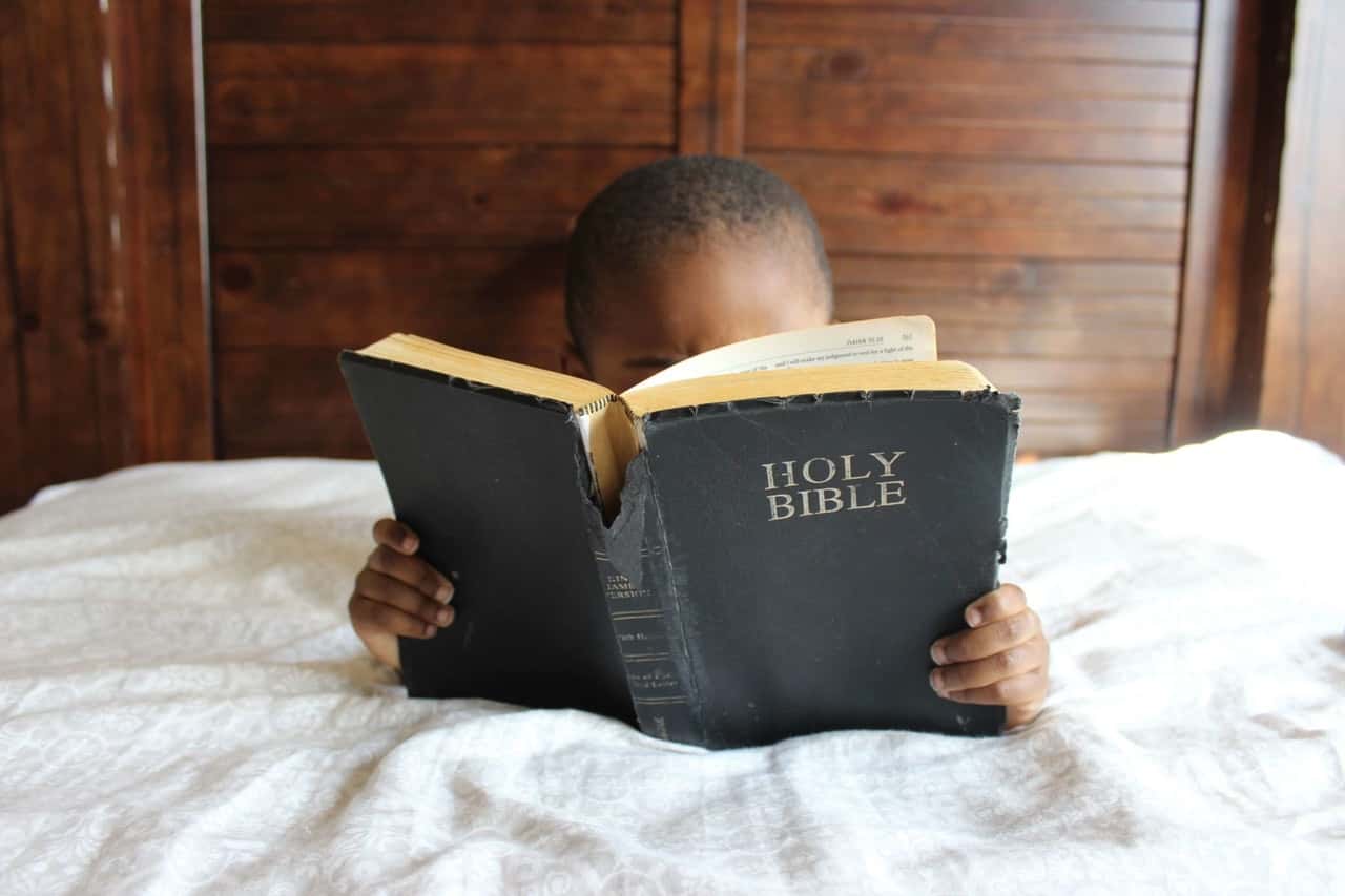 photo-of-child-reading-holy-bible-935944