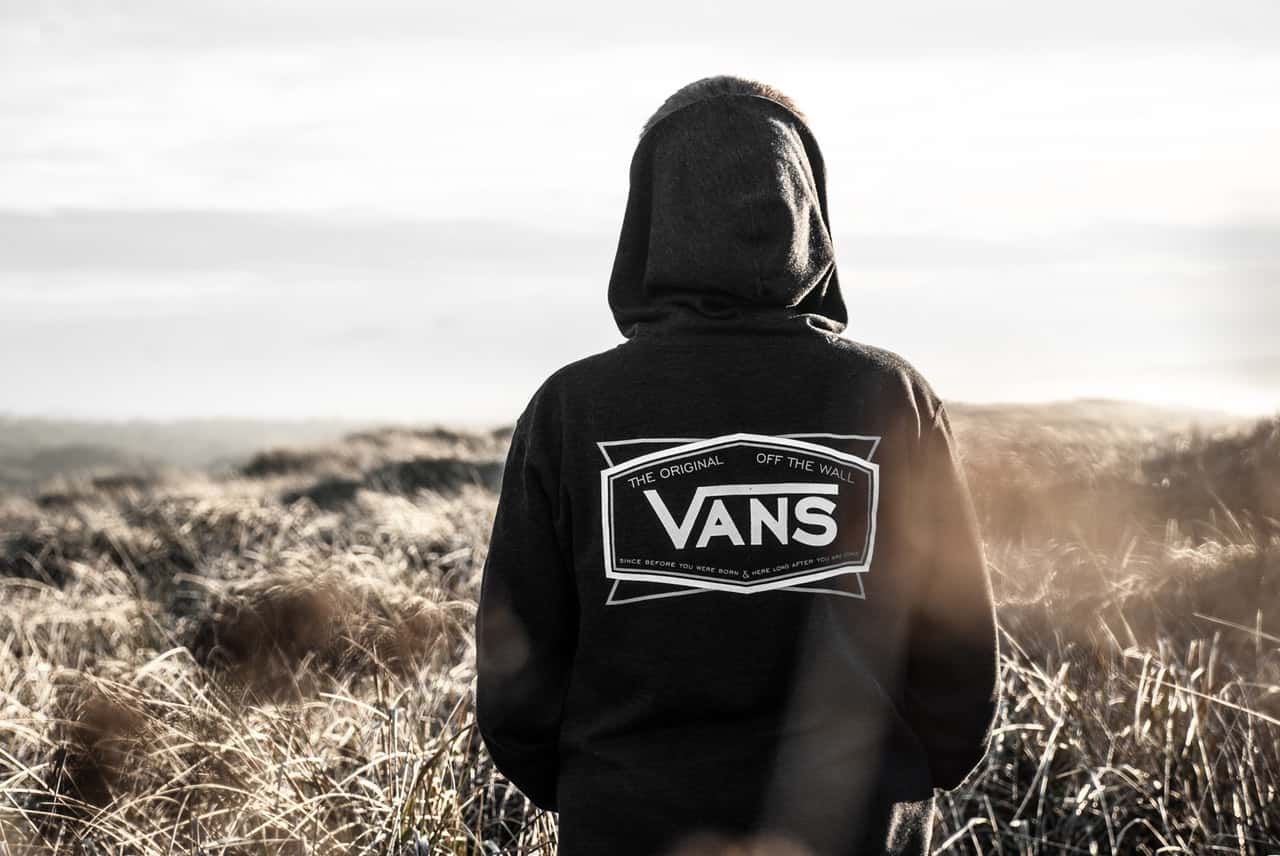 photo-of-person-wearing-black-and-white-vans-hoodie-on-dried-702350