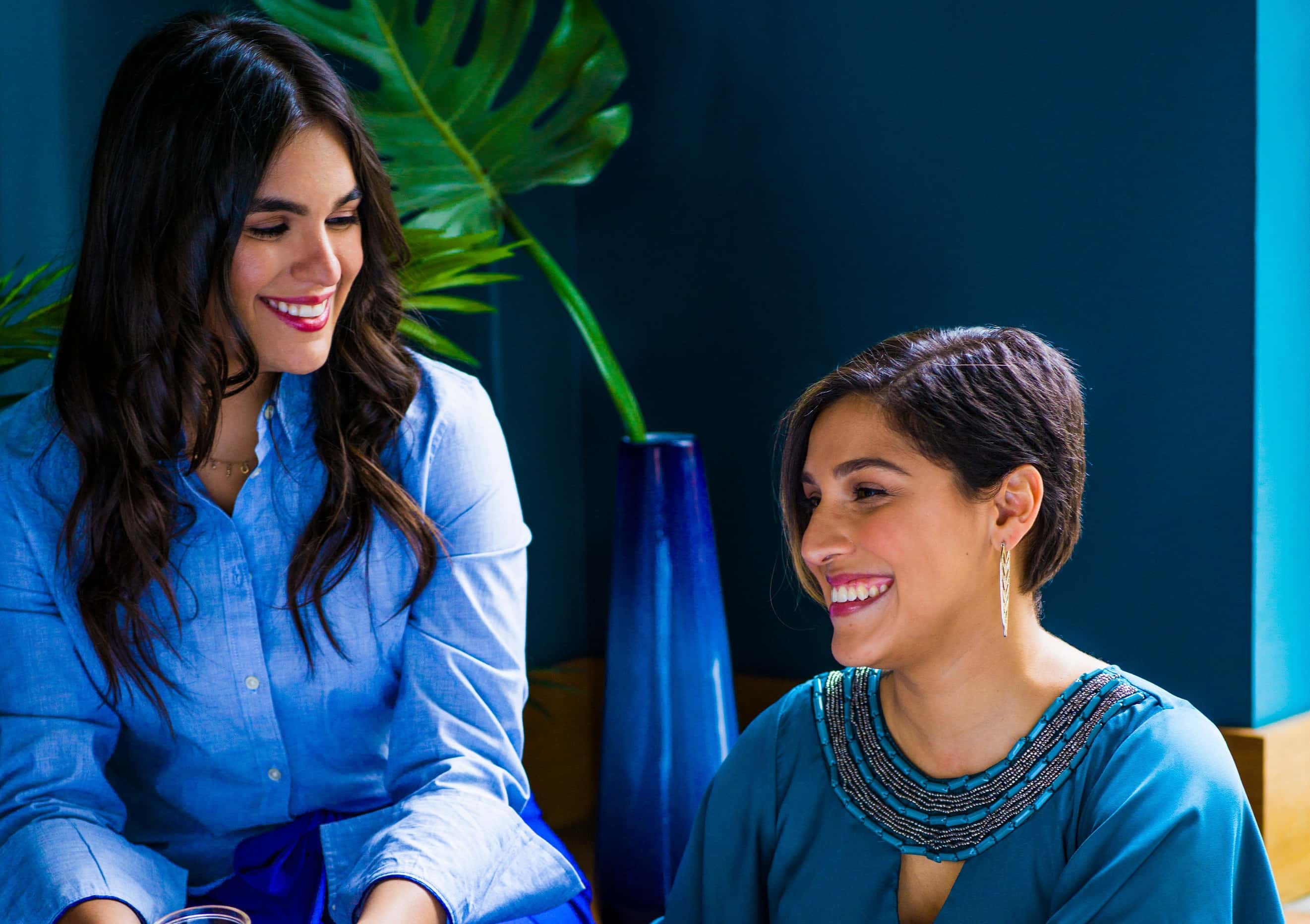 photo-of-two-women-sitting-2422292