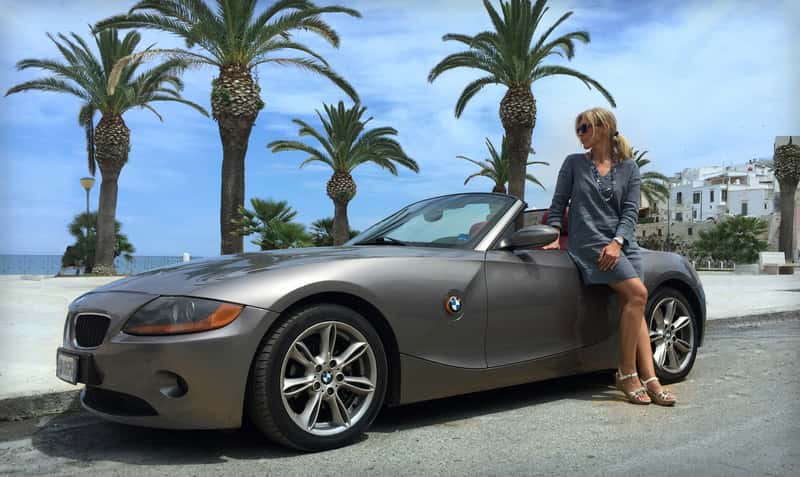 woman-next-to-a-convertible-sports-car_800