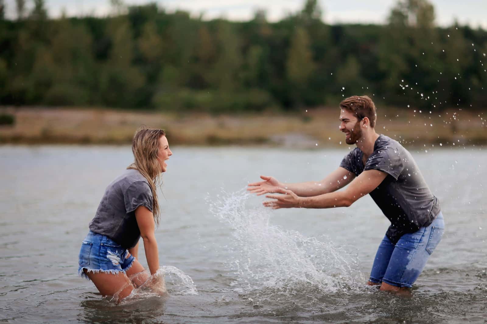 Canva - Man and Woman Playing on Body of Water