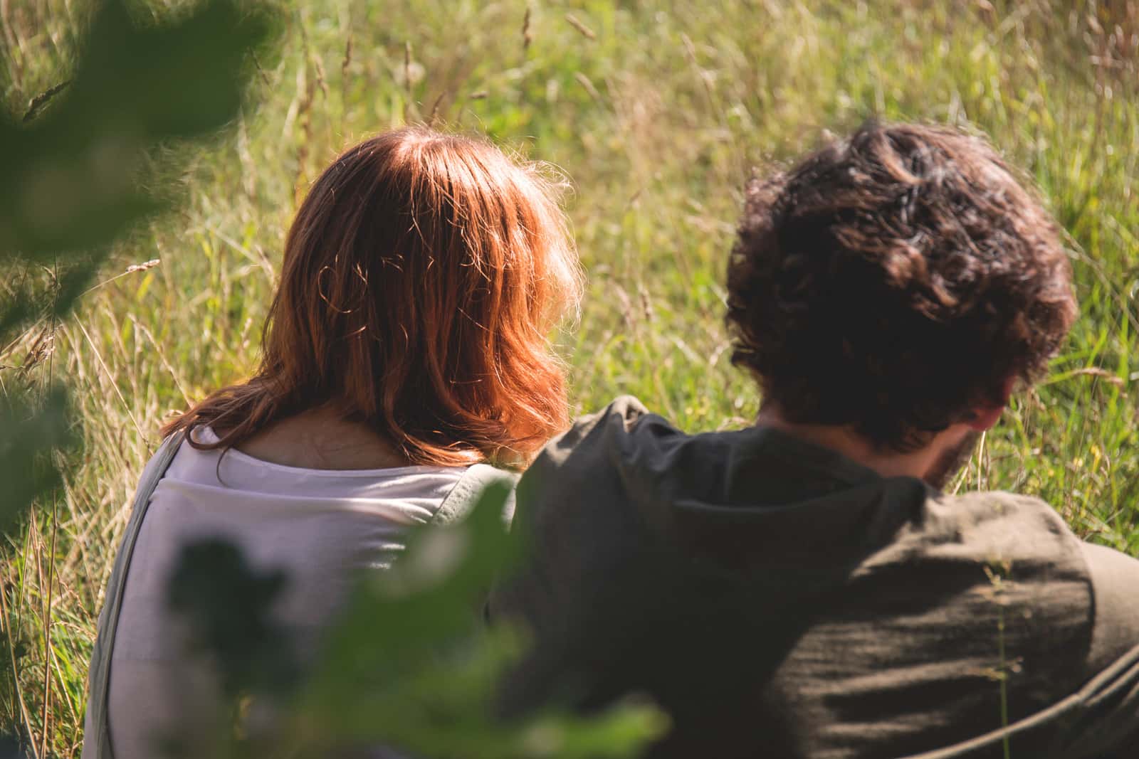 Canva - People Photography of Man and Woman Sitting on Green Grass Field