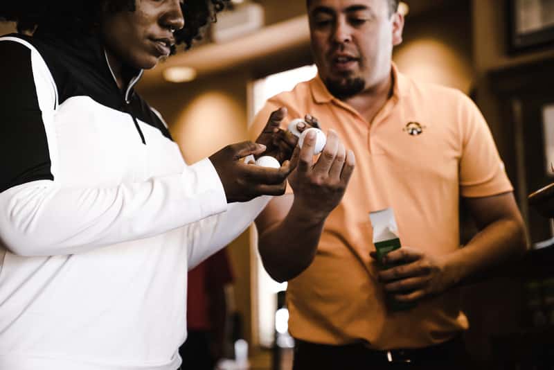 Canva - Woman and Man Looking at Golf Balls(1)