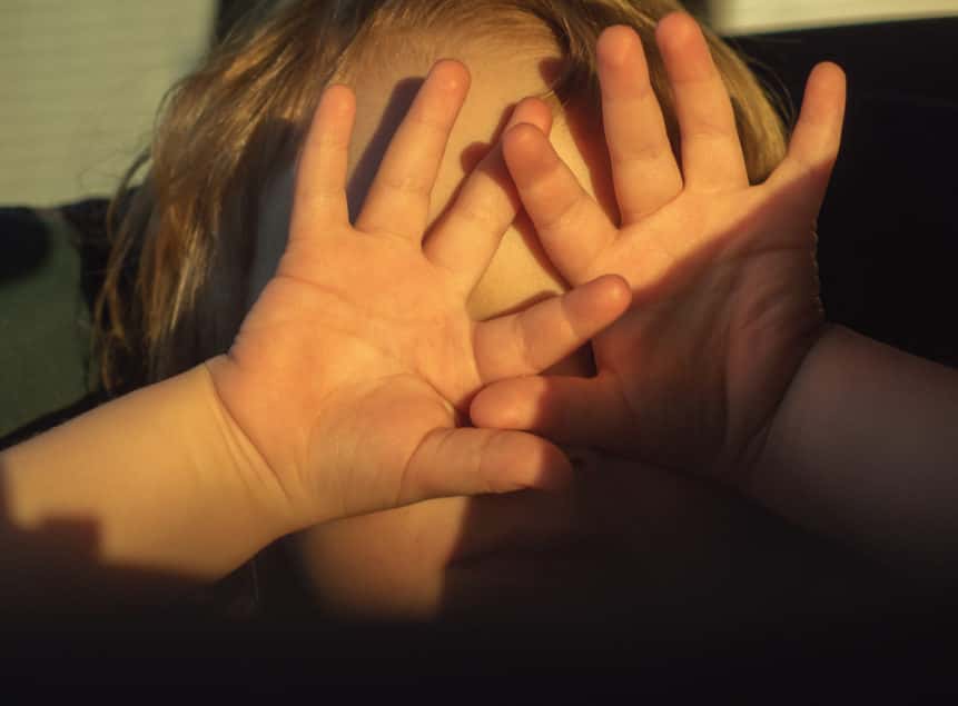 The sun shines in the eyes of the child