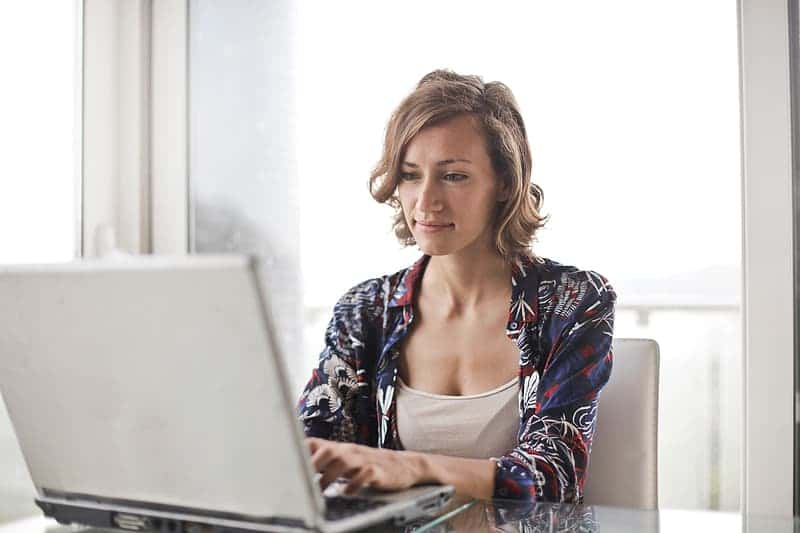 a-young-blonde-woman-working-on-her-laptop-in-the-office-during-the-day-time