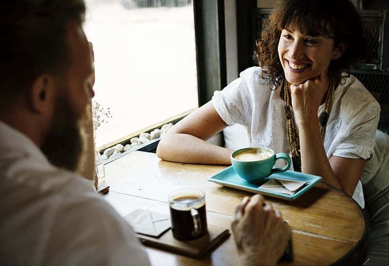 man-and-woman-dating-while-smiling-at-eachother