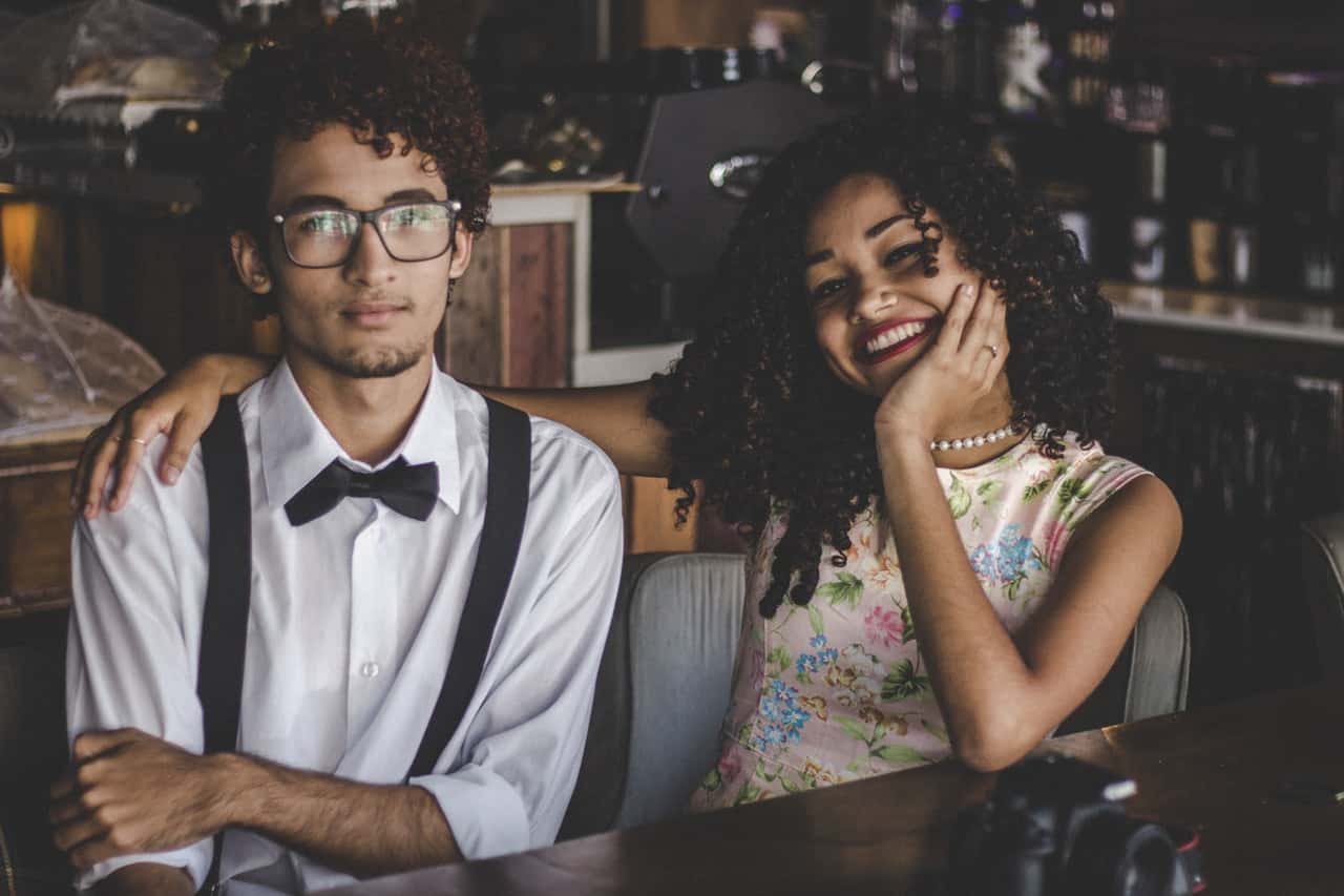 man-and-woman-sitting-on-chair-beside-table-3103223