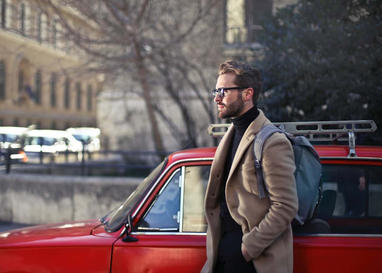 man-wearing-beige-jacket-beside-red-car-843277