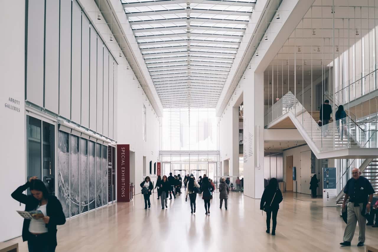people-along-hallway-of-concrete-building-1666667