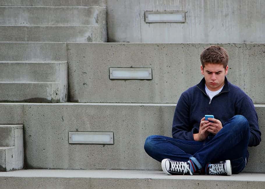 texting-boy-teenager-sitting