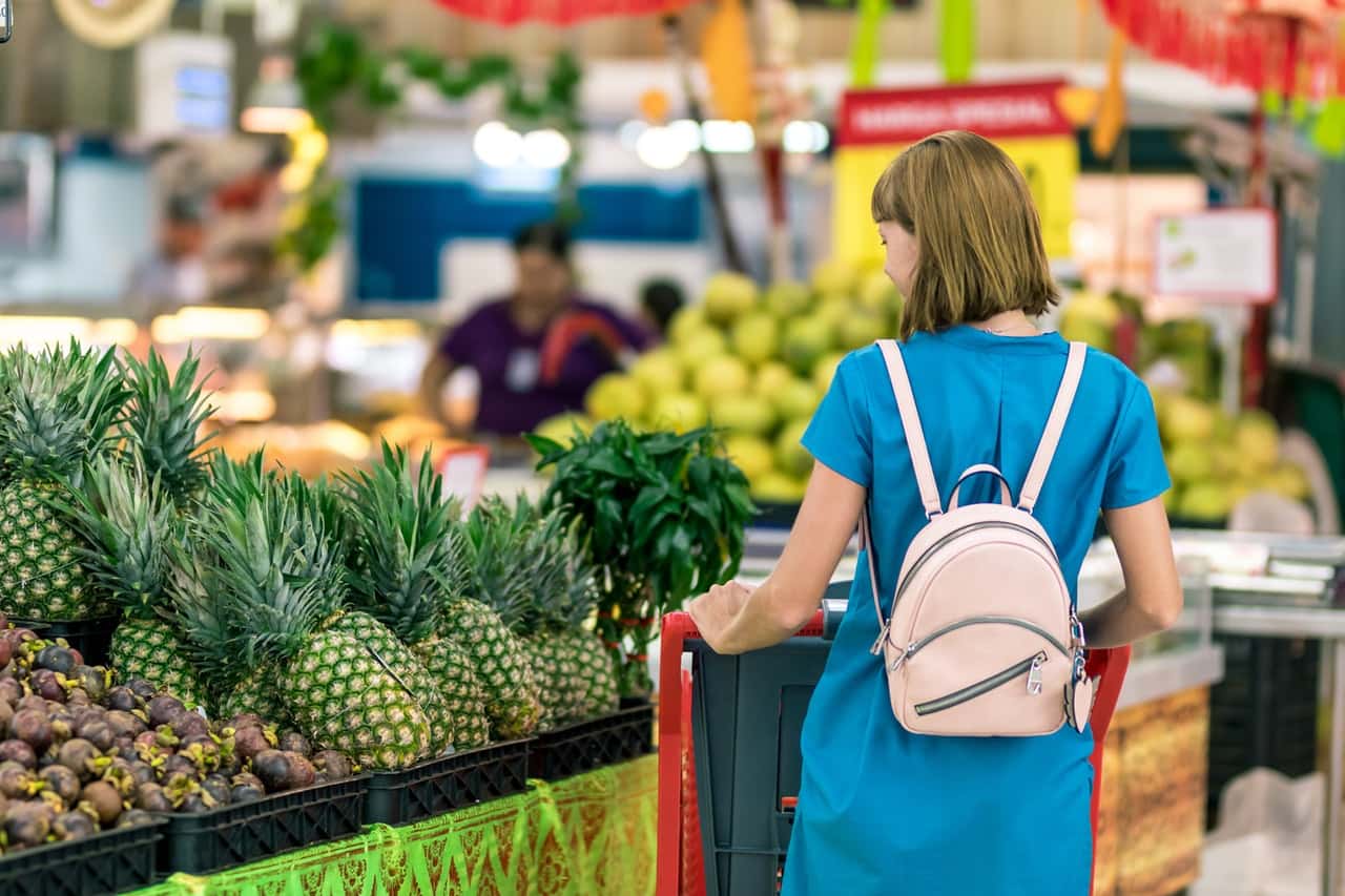 woman-standing-beside-pineapple-fruits-2292919