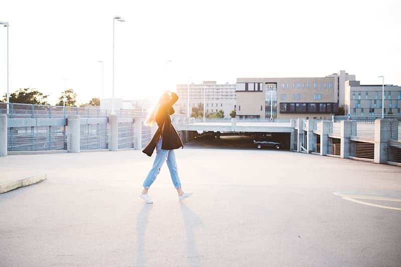 photo-of-woman-walking-on-street-during-daytime