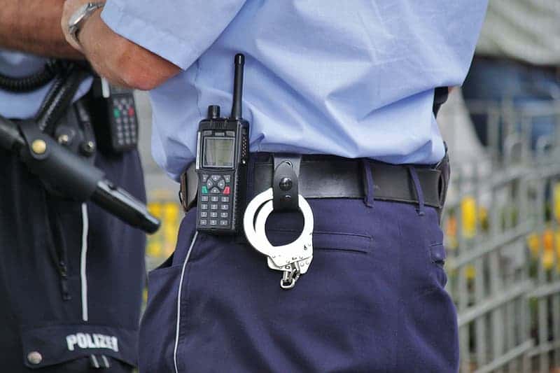 police-with-handcuffs-on-black-leather-belt